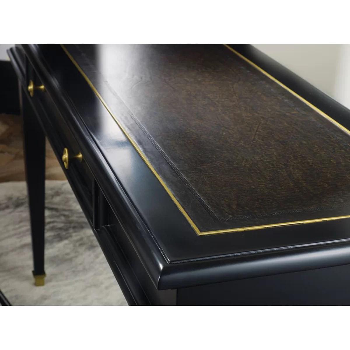 Classic French Black Desk with a tooled inset leather top writing surface, the ebonized and polished finish with brass trim and capitals, with frieze drawer and raised on square tapered legs. 

Dimensions: 60