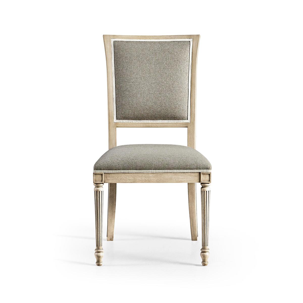 Crafted with meticulous attention to detail, this chair features a sophisticated London Mist wood finish and graceful front turned, tapered and fluted legs, adding a touch of European flair to any dining room.

The hand-upholstered plush,