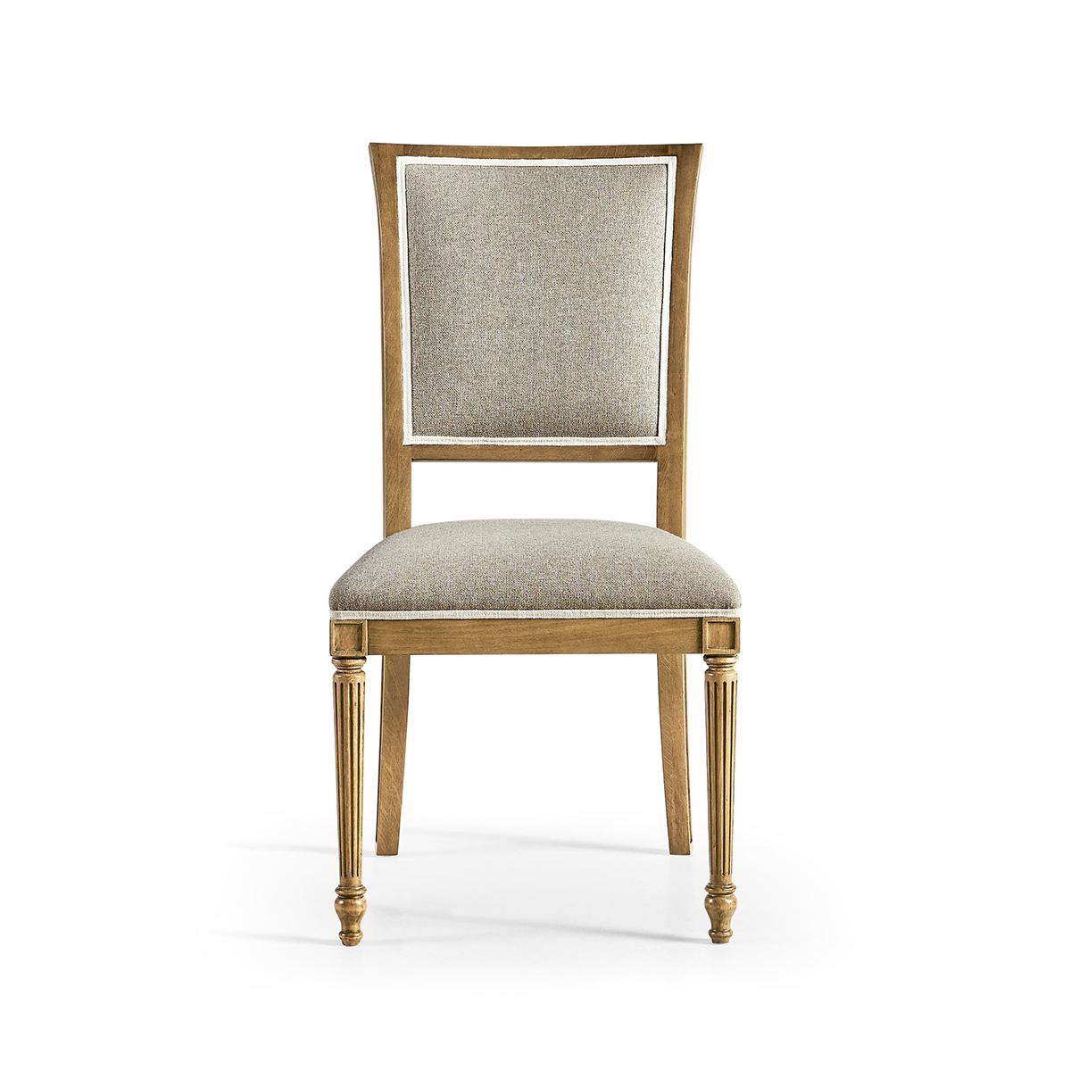 Crafted with meticulous attention to detail, this chair features a sophisticated sunbleached Cherry wood finish and graceful front turned, tapered and fluted legs, adding a touch of European flair to any dining room. 

The hand-upholstered plush,
