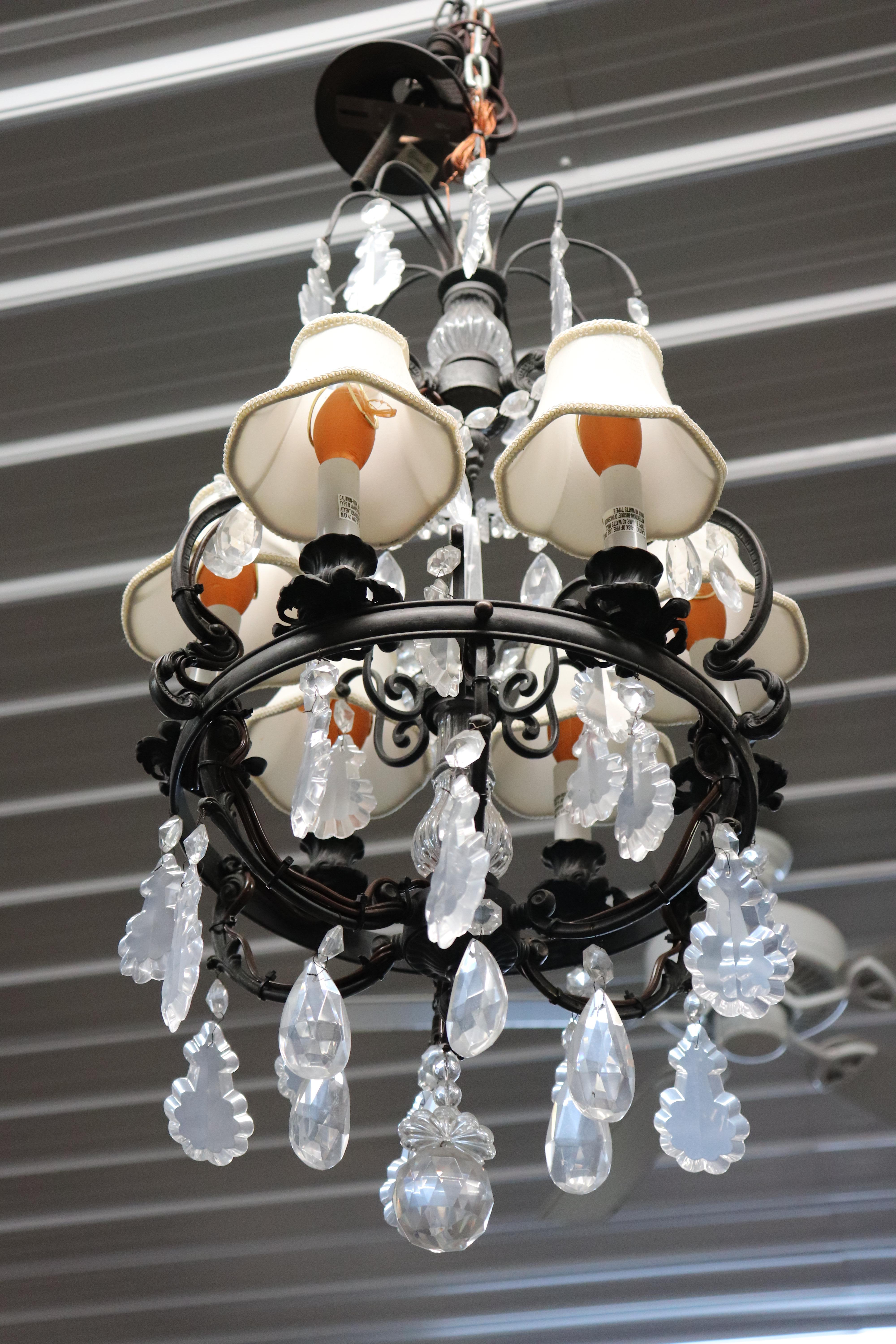 This is a spectacular French-made Louis XV style chandelier with gorgeous cut crystal prisms and tear drops everywhere. The chandelier is in good condition with shades for each of the 6 lights and beautiful metal-work. Dates to the 160s