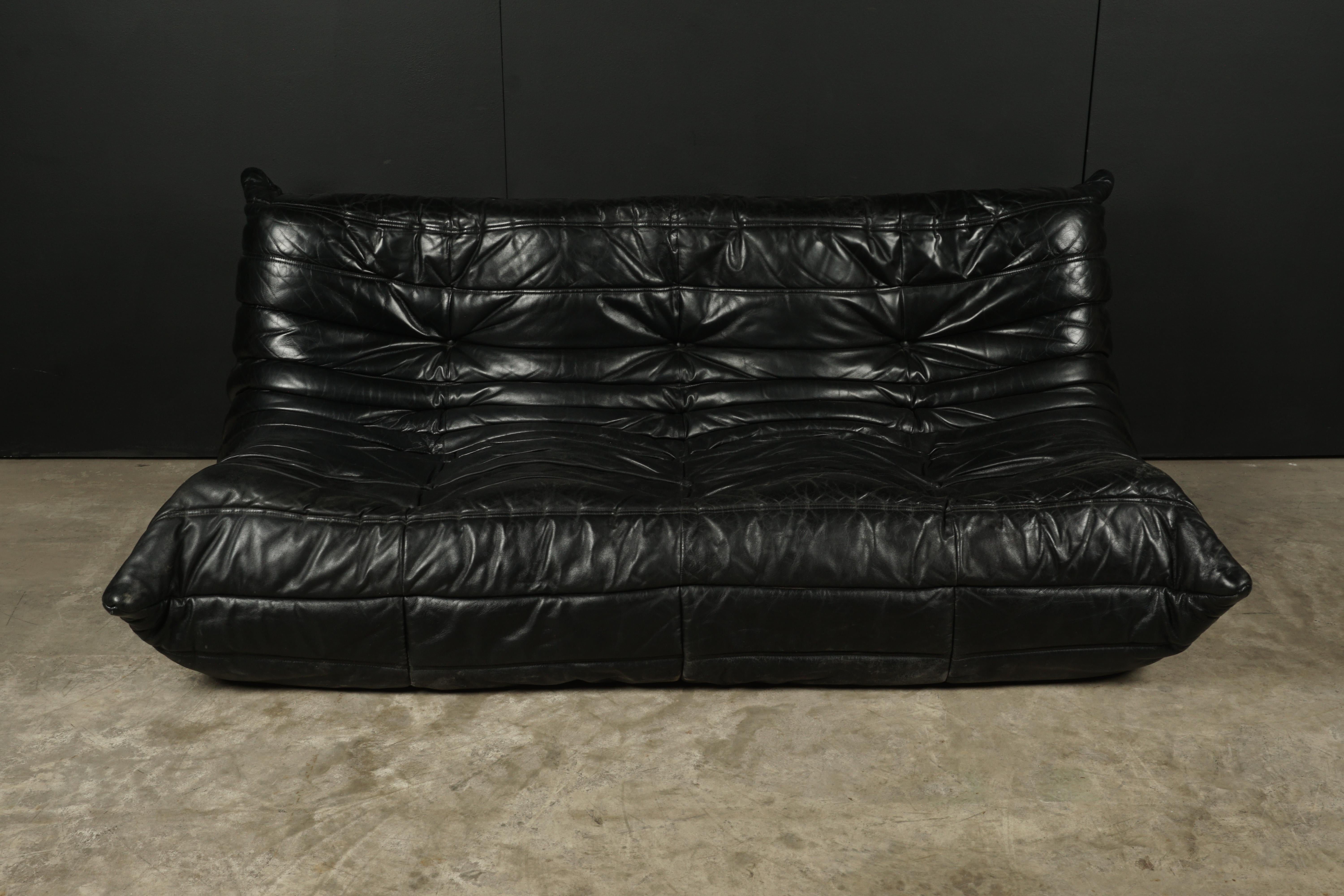 Rare vintage leather Togo sofa by Michel Ducaroy for Ligne Roset. Original black leather upholstery. Label has been cut, but partly remains. Very comfortable.