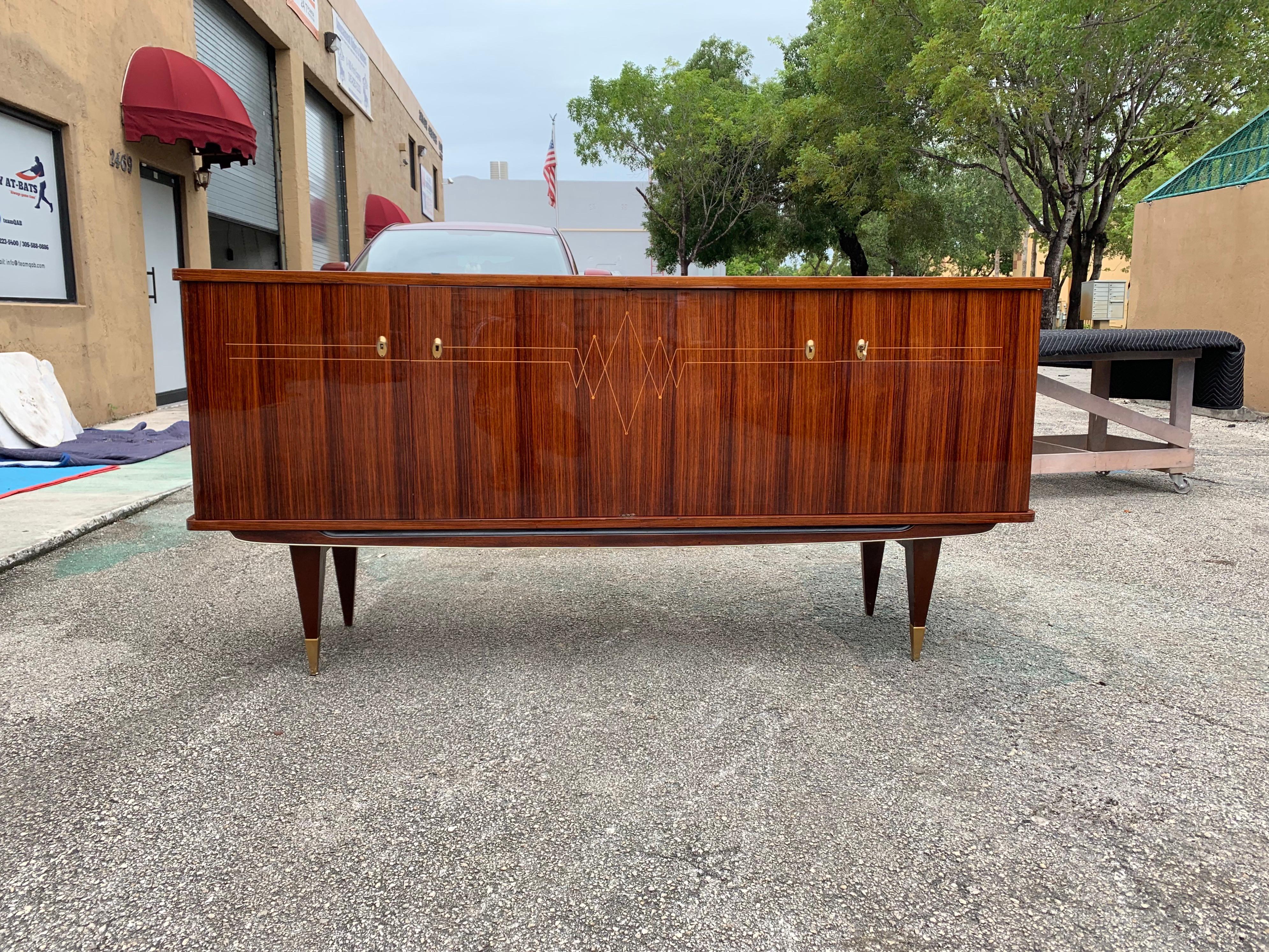 Classic French exotic Macassar sideboard or buffet, circa 1940s. This piece displays very high levels of craftsmanship, the sideboard are in perfect condition, with 3 shelves adjustable and you can remove all the shelves if you need more space, with