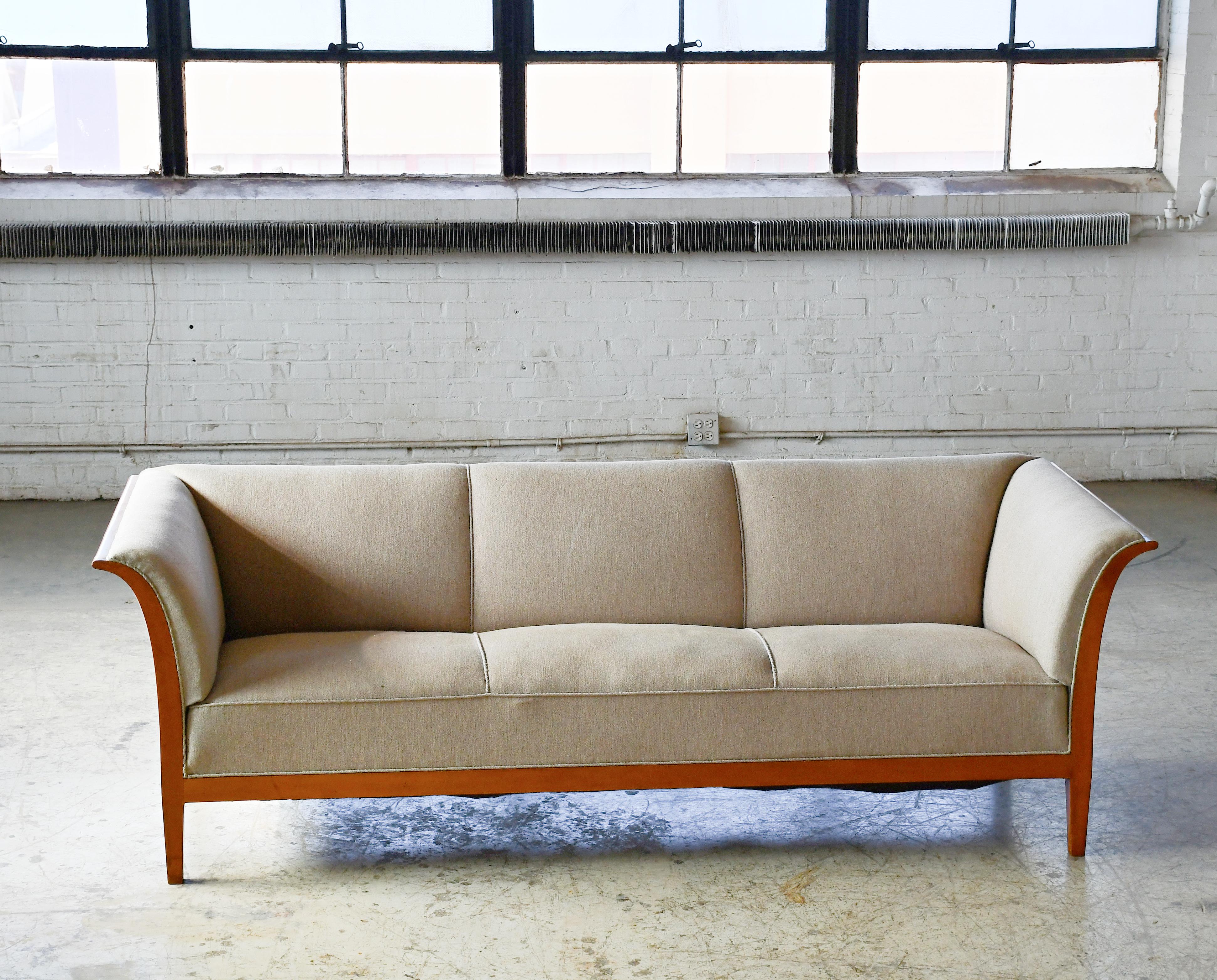 This elegant and generously sized three-seat sofa was designed and made by the Danish Master Cabinetmaker, Frits Henningsen in various size up through the 1930s till about 1950. This very fine and sizeable specimen was most likely produced between