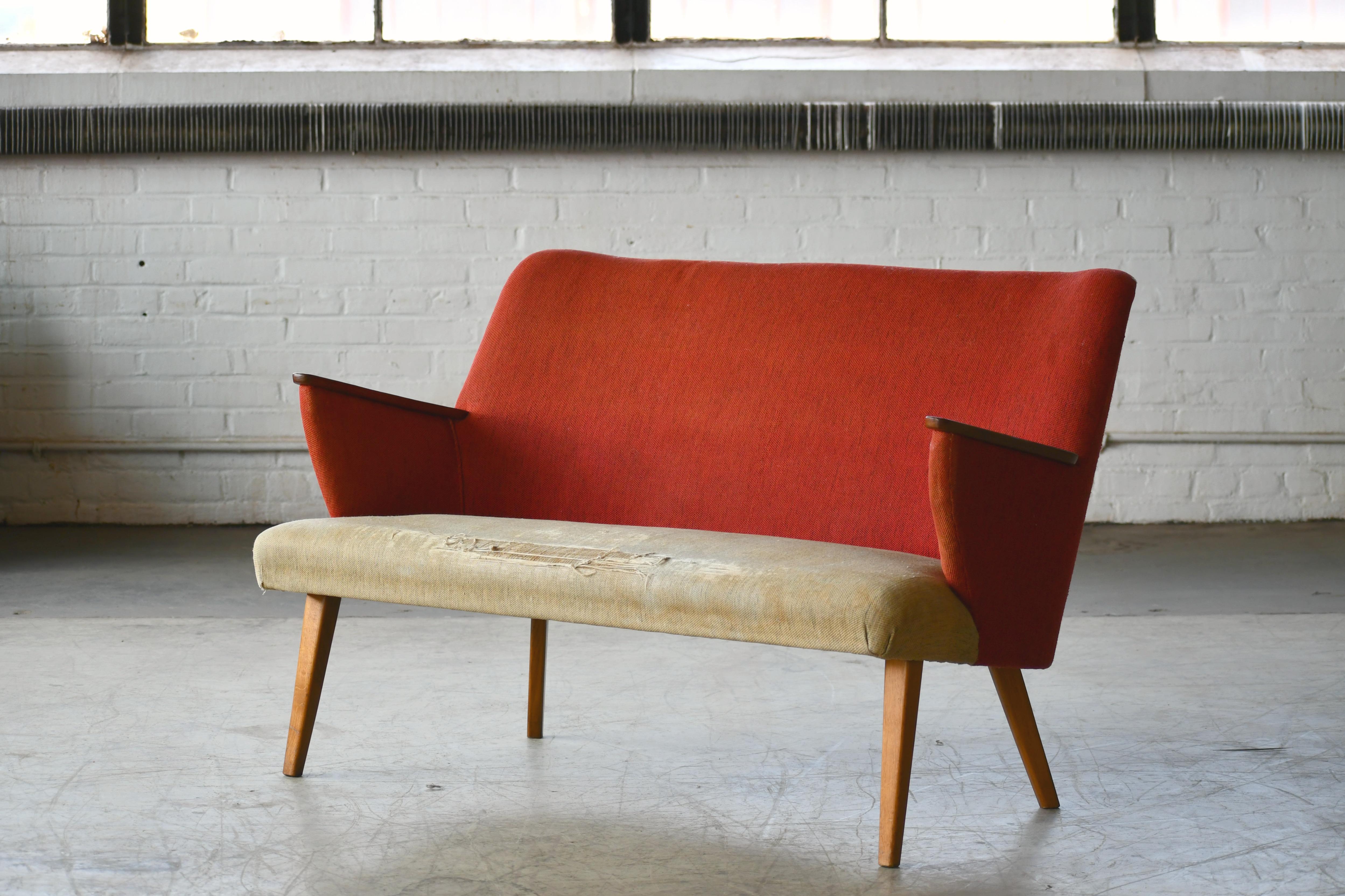 Classic and very elegant lines very much in the style of the early Danish iconic designers/makers, Frits Henningsen made circa late 1940s-1950s. Back and seat nice and firm and frame on Cuban mahogany legs remains sturdy. The sofa has been