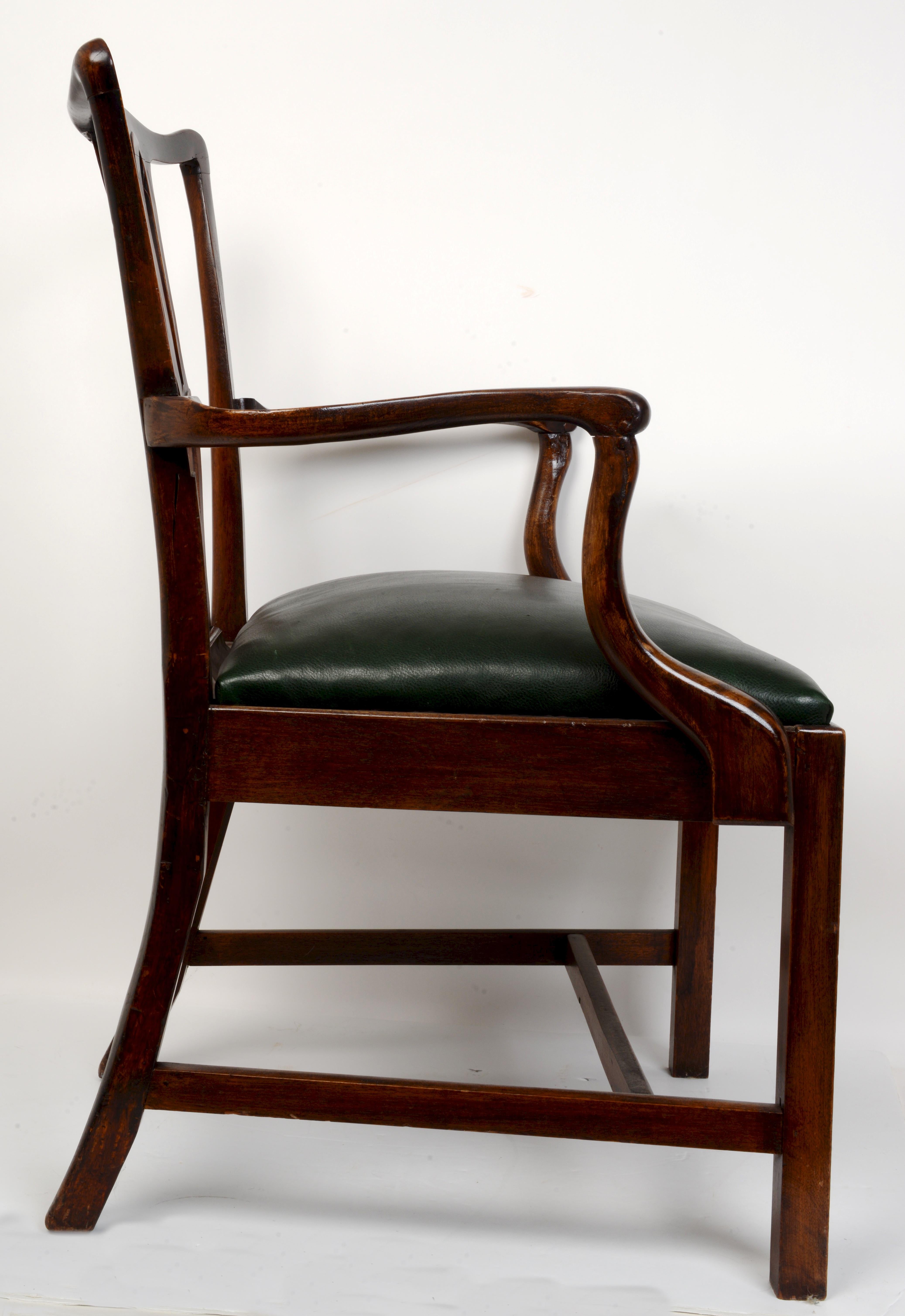 Geo III Style open arm chair, 19th. The carved mahogany armchair in the Thomas Chippendale 'Gothick' manner with a serpentine topped rail above a pierced splat. The top rail has continuous carving completing the arched, bulbous designed backrest. It
