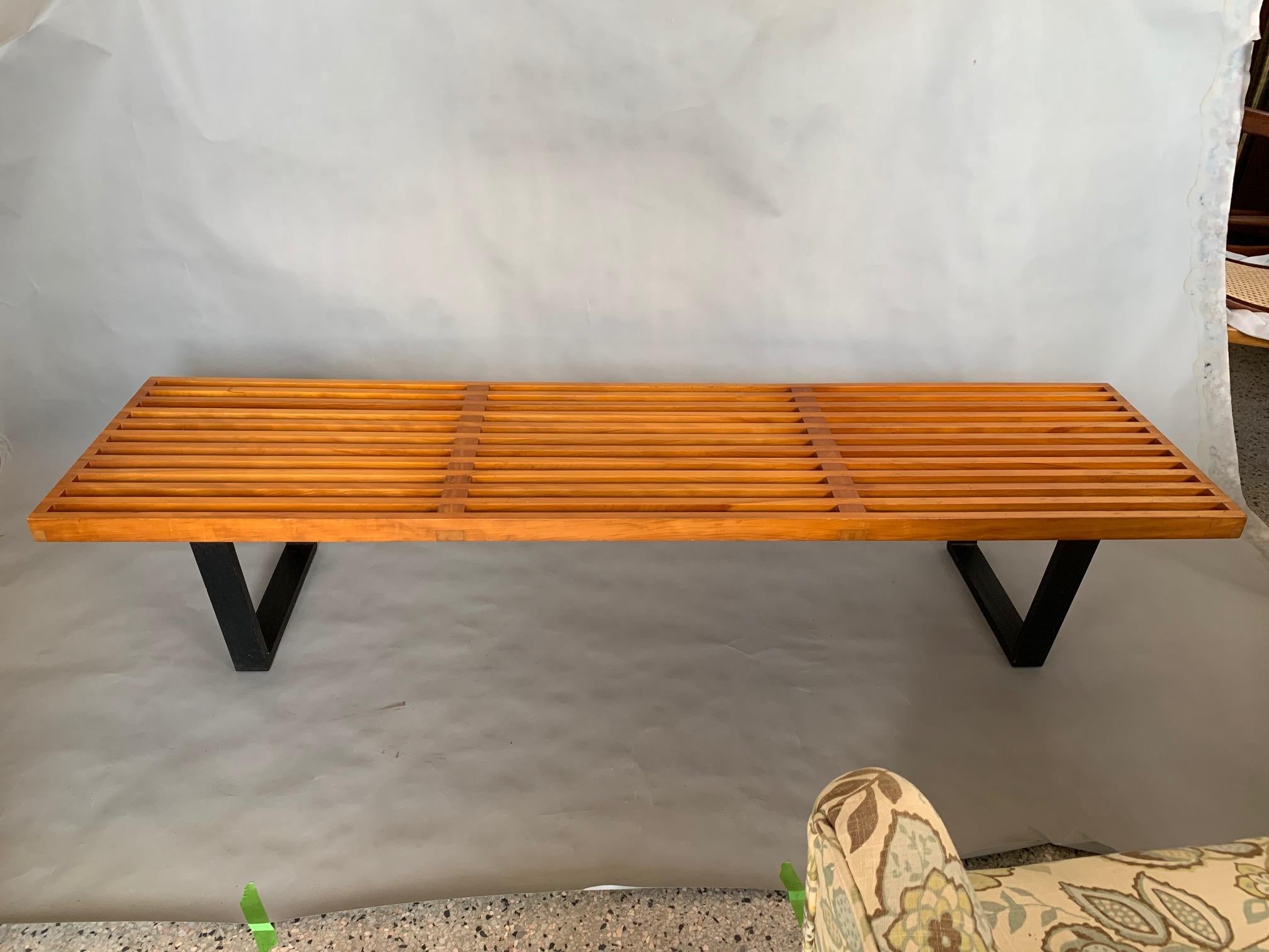 A classic slat bench by George Nelson for Herman Miller. Original foil label, beautiful, rich yellowed patina with factory finish-a true survivor. Rare to find in this condition. The 6ft length makes it very practical and can be used in any interior