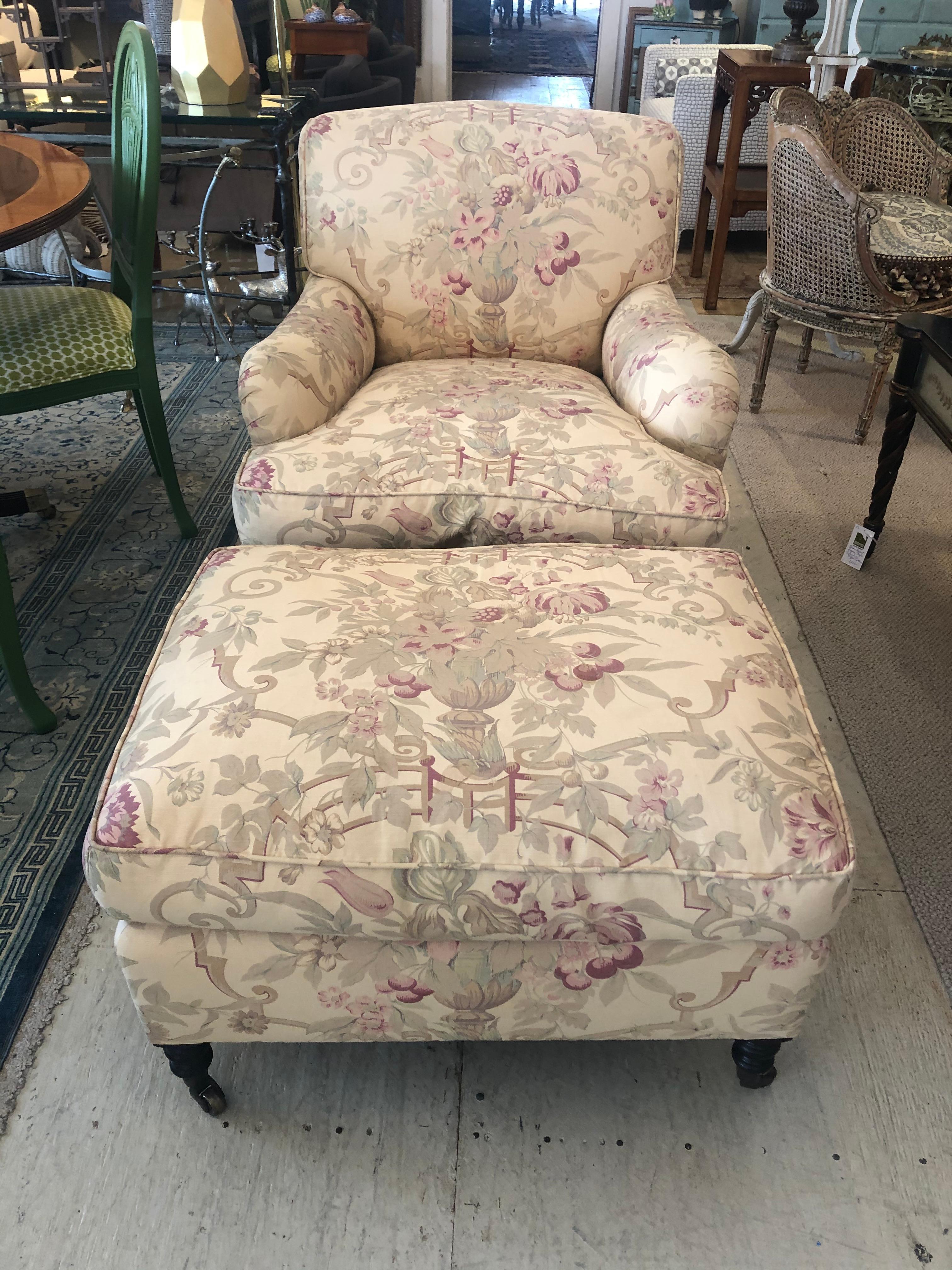 A classic George Smith large Signature Standard club chair with matching ottoman upholstered in their famous romantic faded Gollut fabric #5. Down filled seat and ottoman cushions. Fixed back cushion and coordinating throw pillow. 
No label, but