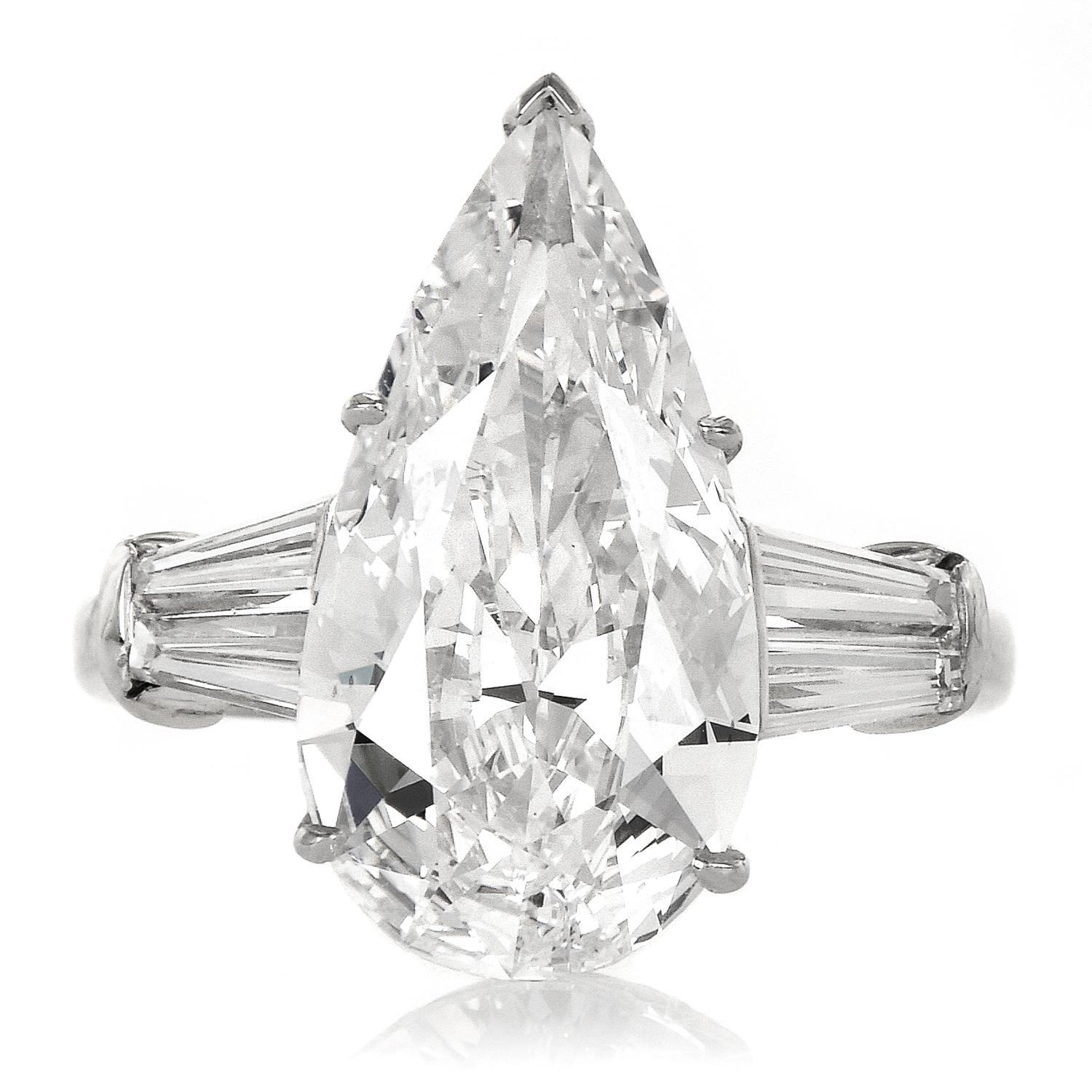 This exquisite diamond engagement ring is centered by one elongated pear shape diamond of approx. 6.16cttw. GIA graded the diamond, with the highest color grade, D color, and an excellent clarity grade of VS1.

The sides are graced by 4 tapered