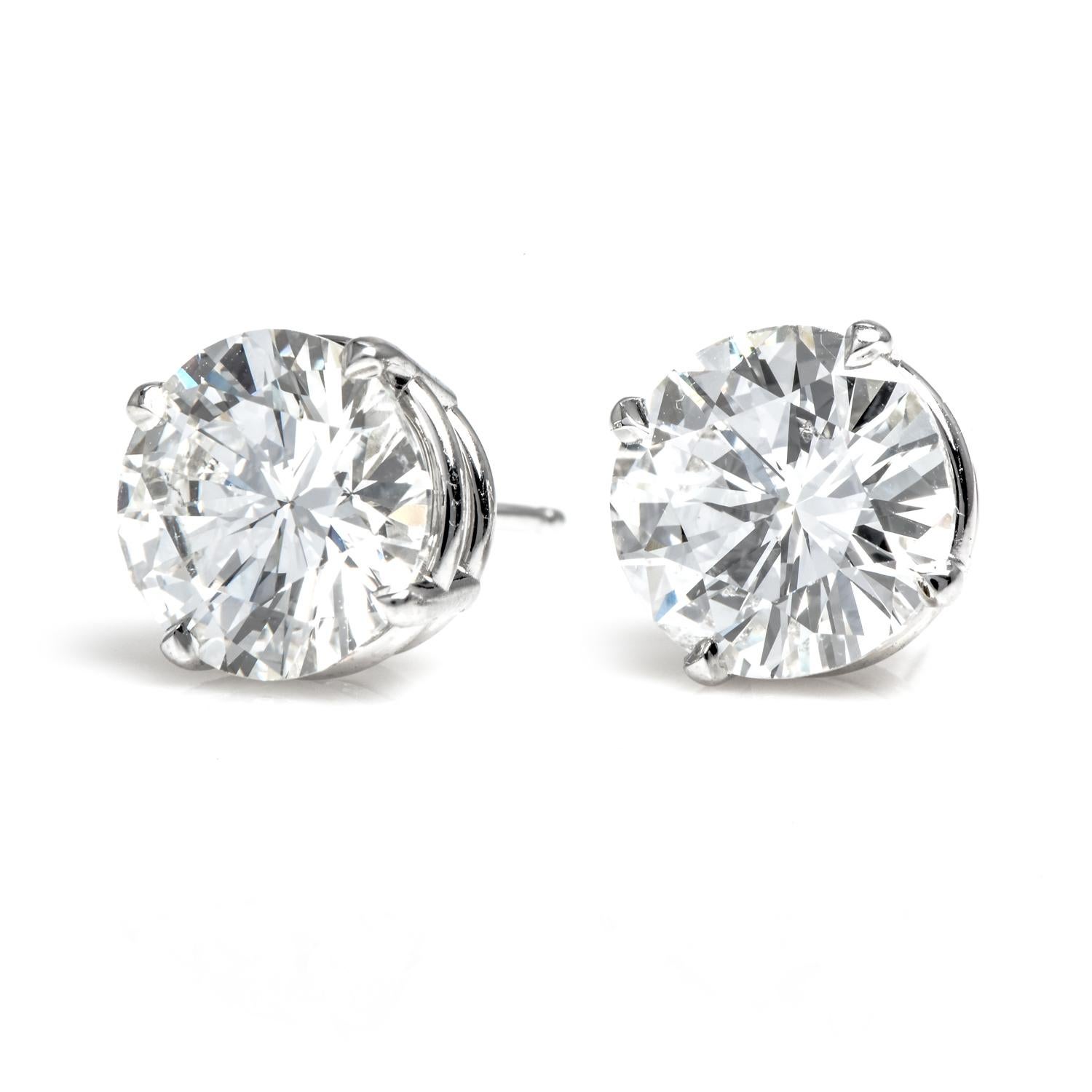 These must-have earrings are crafted in 18K white gold set with  2 round faceted Brilliant-cut diamonds weighing approx  4.03 carats in total. They are GIA Certified, one 2.00 carats I color, SI1, and 2.03 carats H color SI2 Prong Set in 18k white