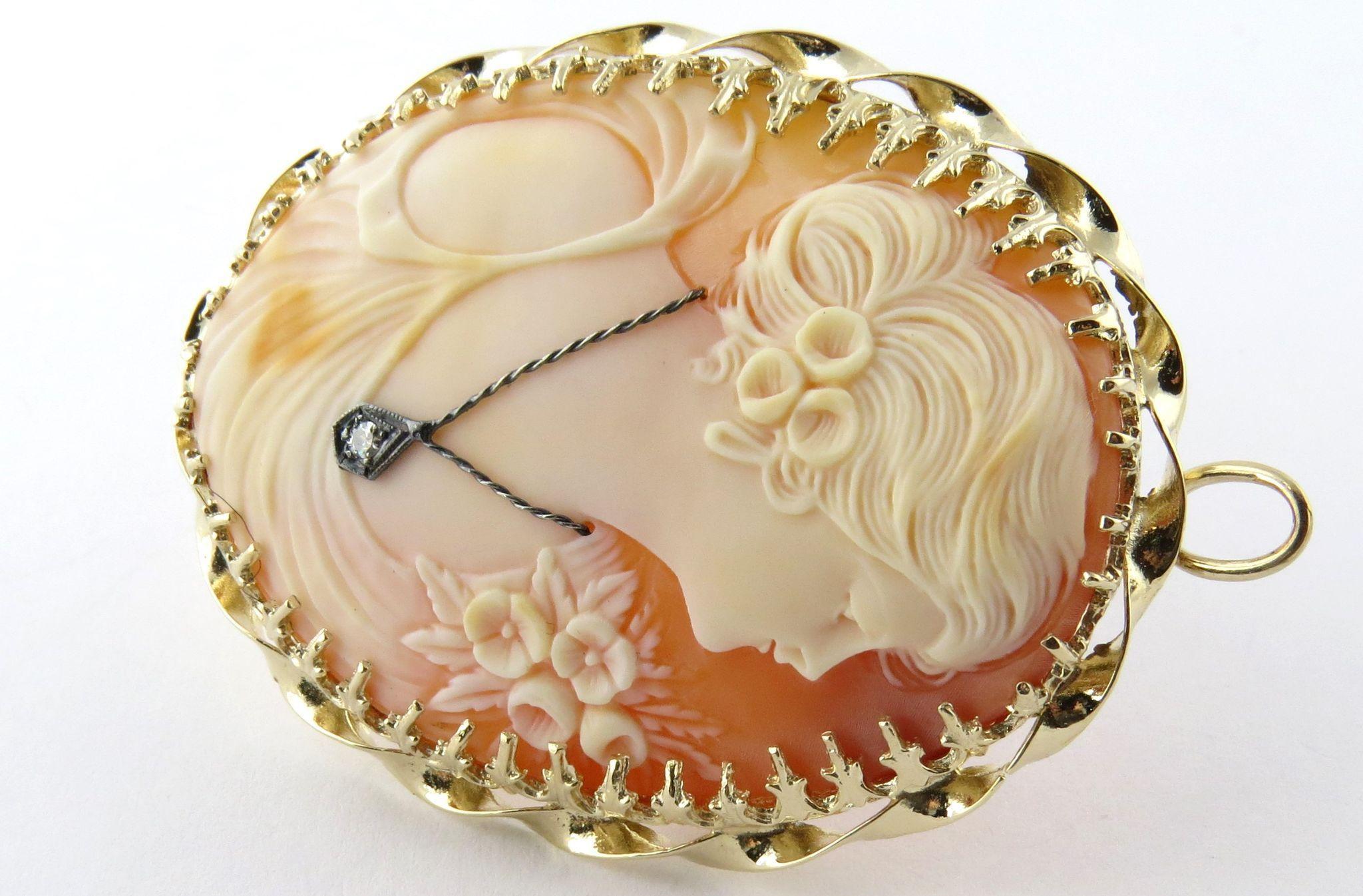 Classic Vintage Gibson Girl Cameo with Diamond Necklace 14K Yellow Gold Pin or Pendant. 

Intricately hand carved shell of a classic Gibson girl set in a pronged twisted gold frame. She wears a white gold diamond necklace around her neck adding to
