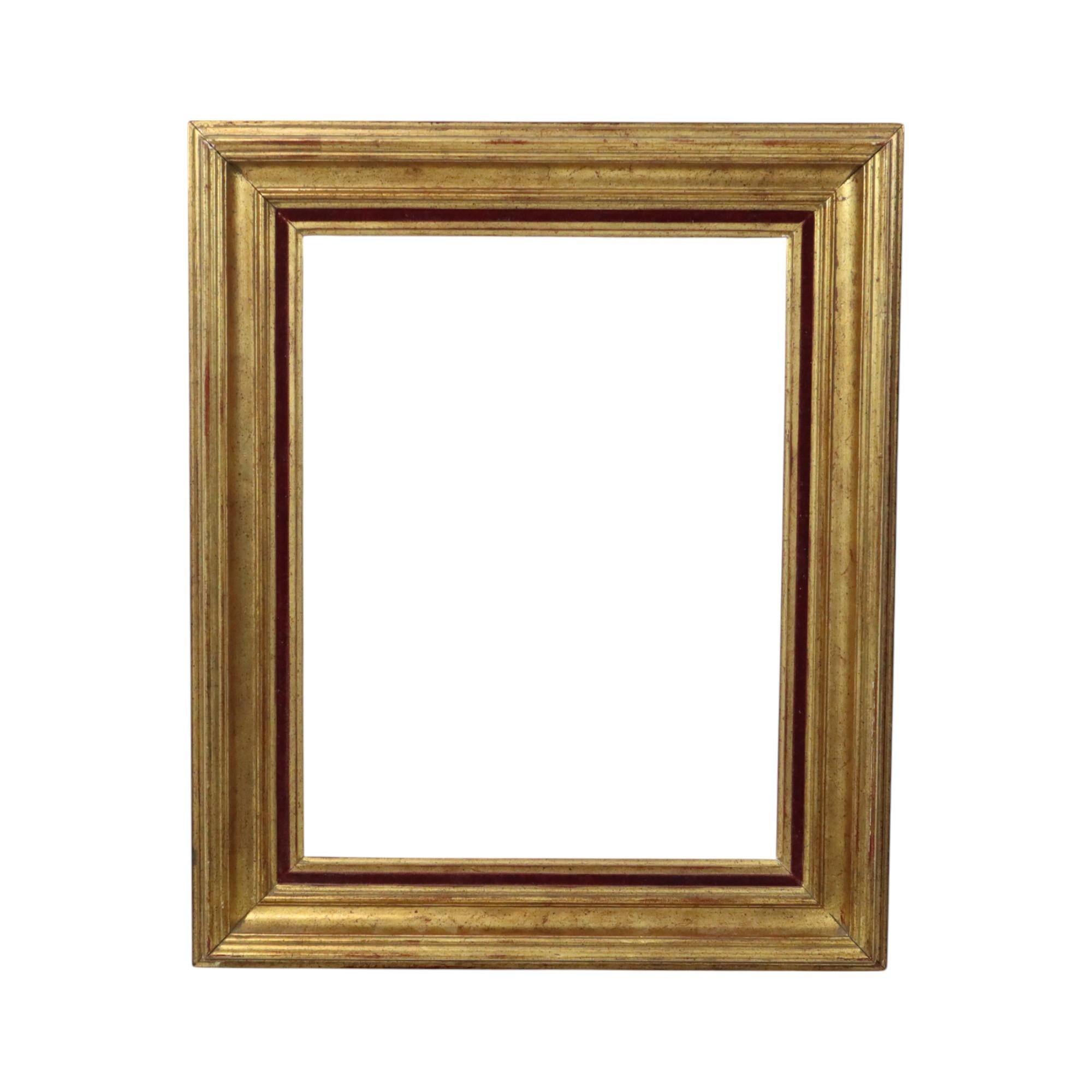 Old gold-colored wooden frame with a beautiful patina of age, entirely in classic style, decorated all around with a red velvet band, circa mid-20th century.

A nice size frame for creative use, great as a mirror, or of course to display an existing