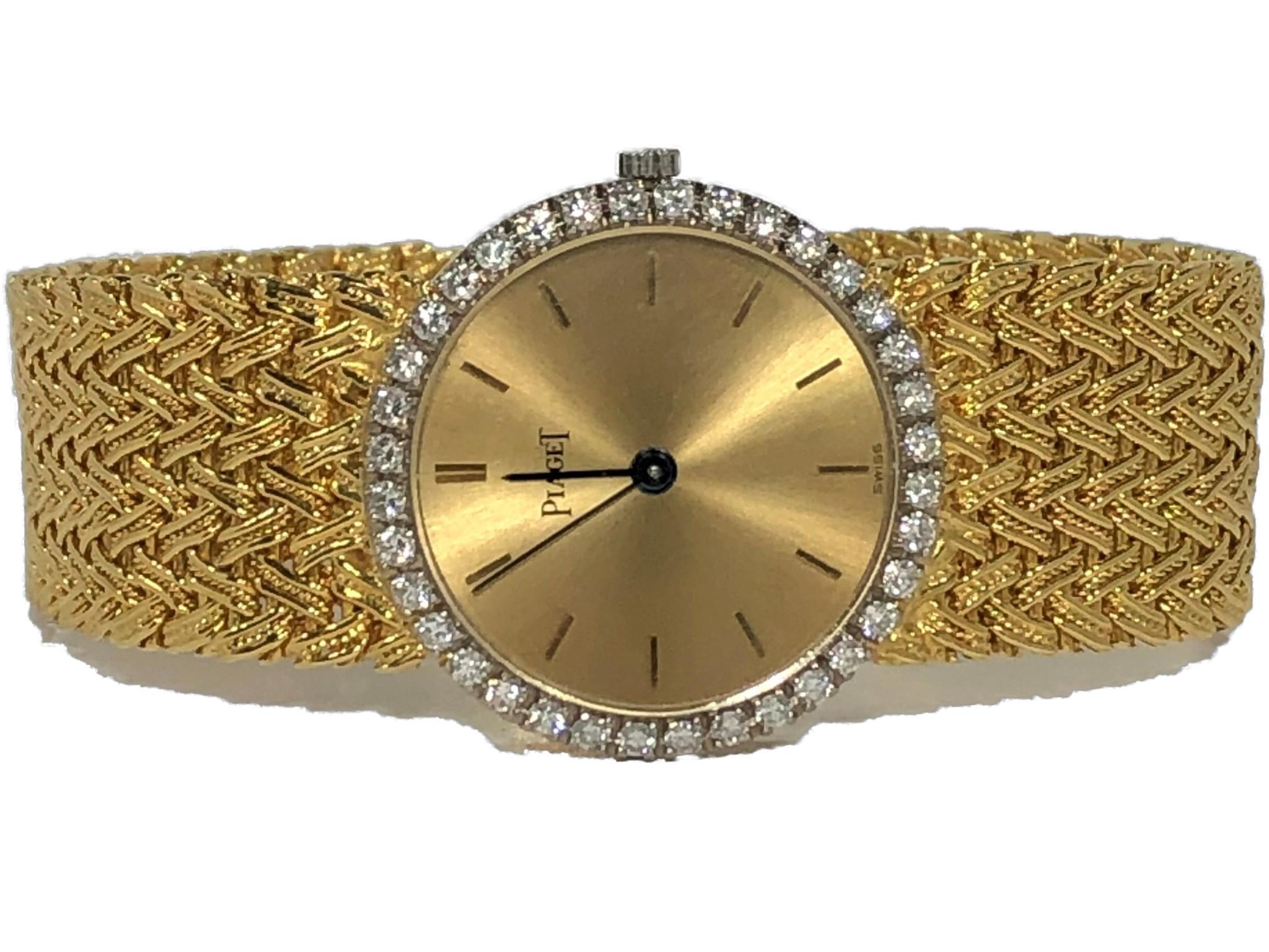 A ladies 18K yellow gold wristwatch by Piaget with a diamond bezel measuring 24mm in diameter. Centered around a champagne color dial with gold, stick markers, the black hands and logo contrast beautifully, and are easy to read. The diamonds weigh a