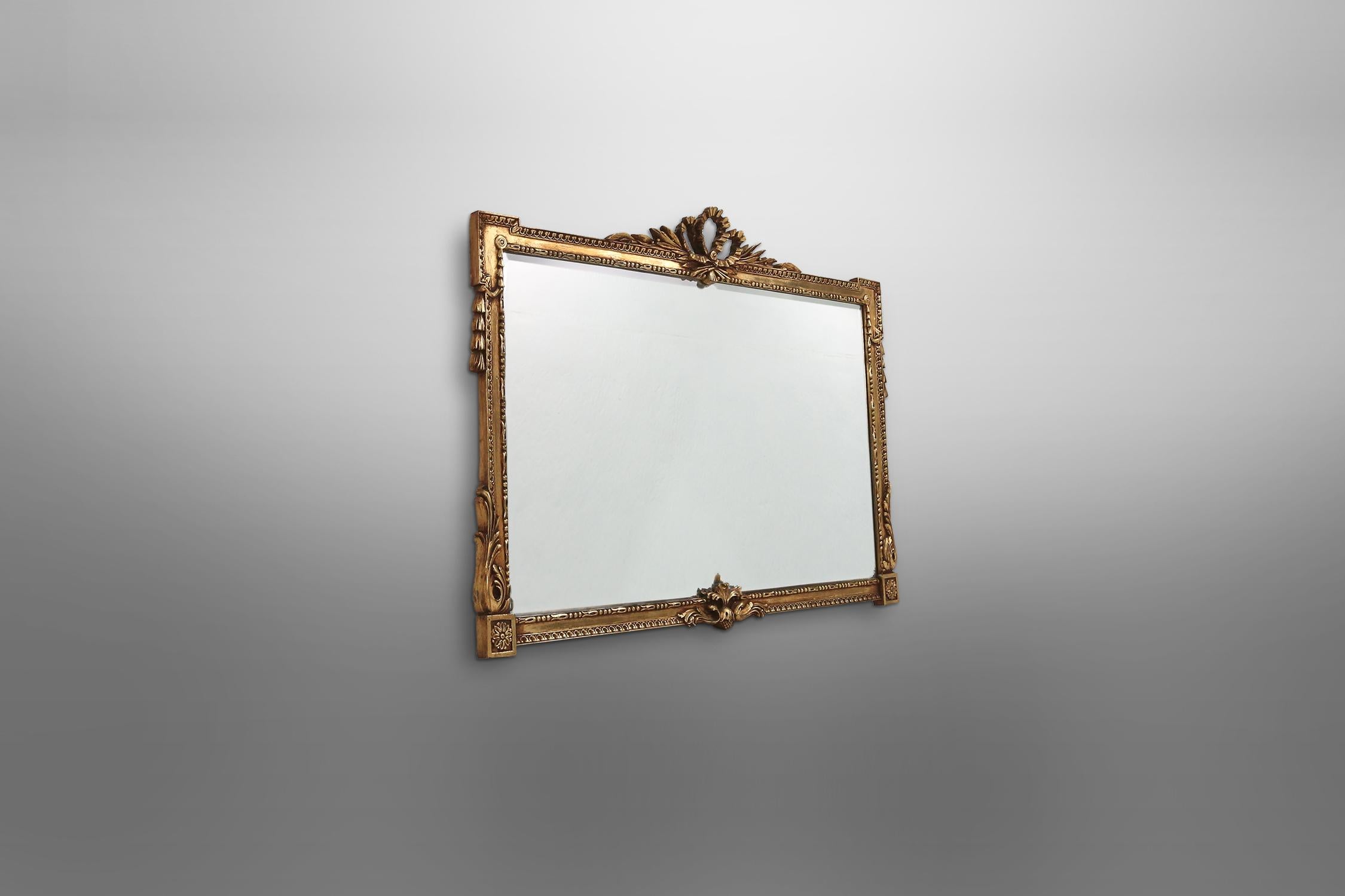 Big golden color mirror with beautiful sculpture details and with a cut glass mirror.