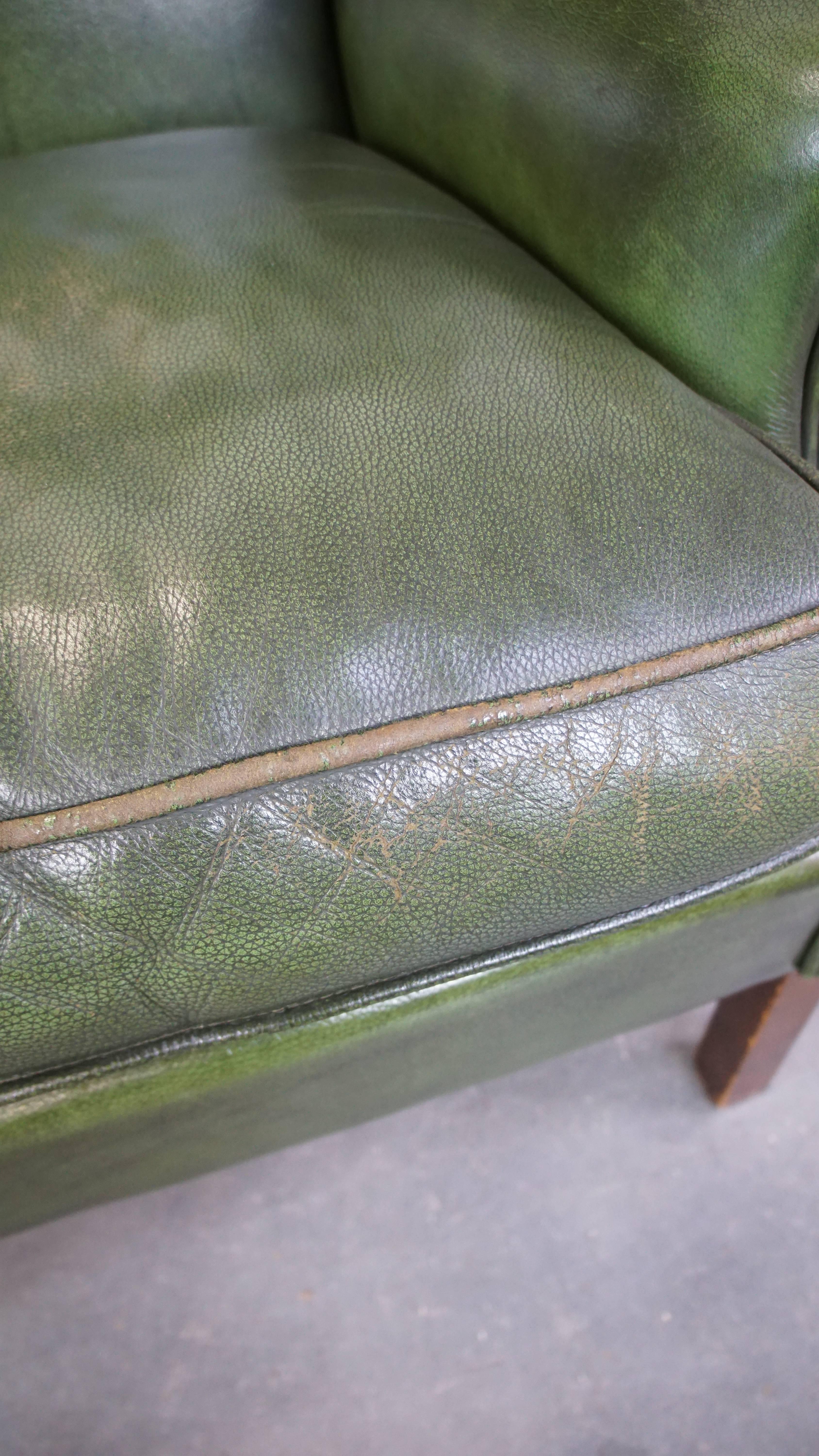 Classic green cowhide English Chesterfield wing chair with a comfortable seat For Sale 4