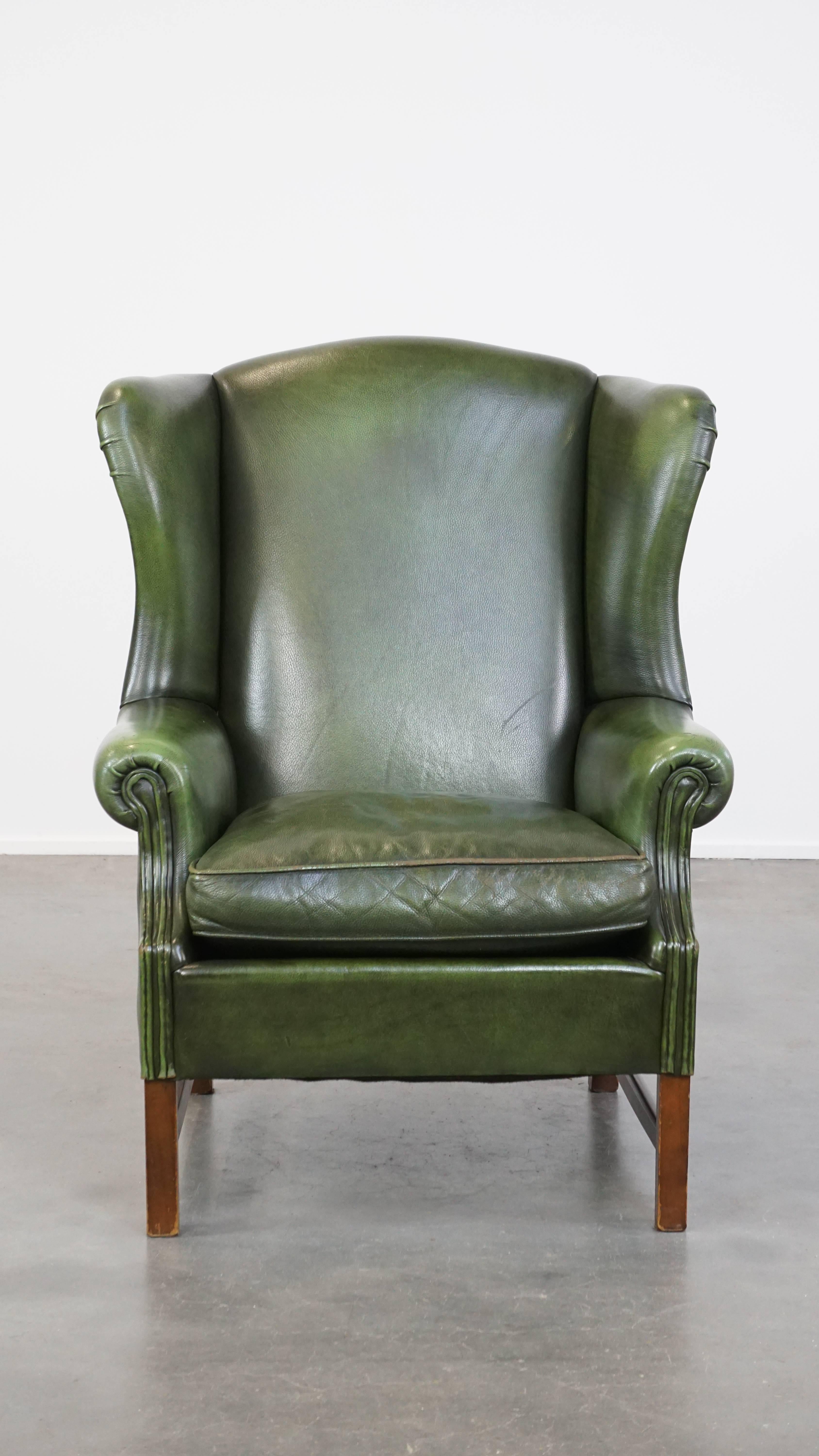 Offered is this classic green and smooth English chesterfield leather wing chair in good condition with a comfortable seat.

This leather wing chair is the perfect addition for lovers of chesterfield furniture who do not like capitons. Its beautiful