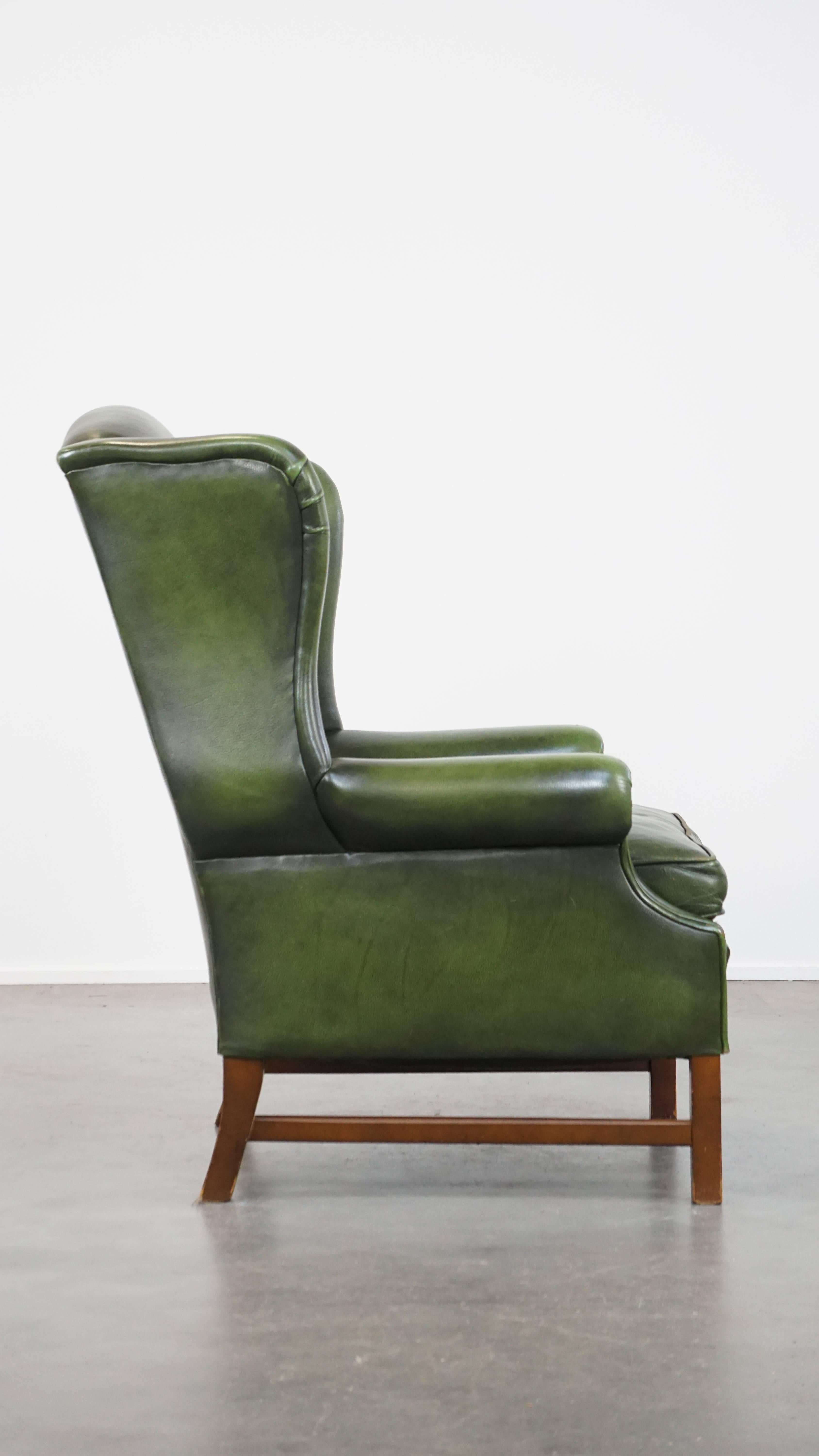 Hand-Crafted Classic green cowhide English Chesterfield wing chair with a comfortable seat For Sale