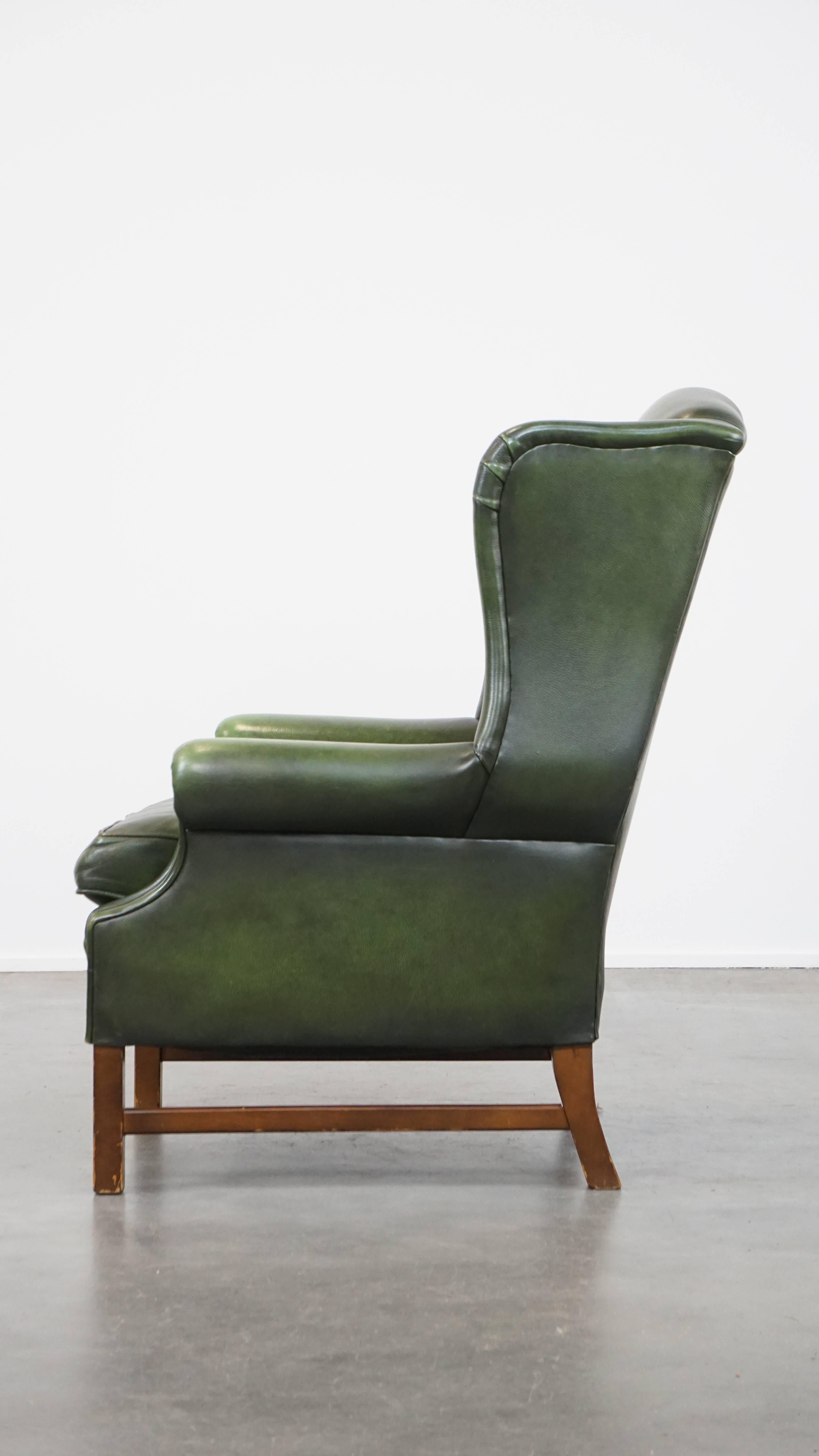 20th Century Classic green cowhide English Chesterfield wing chair with a comfortable seat For Sale