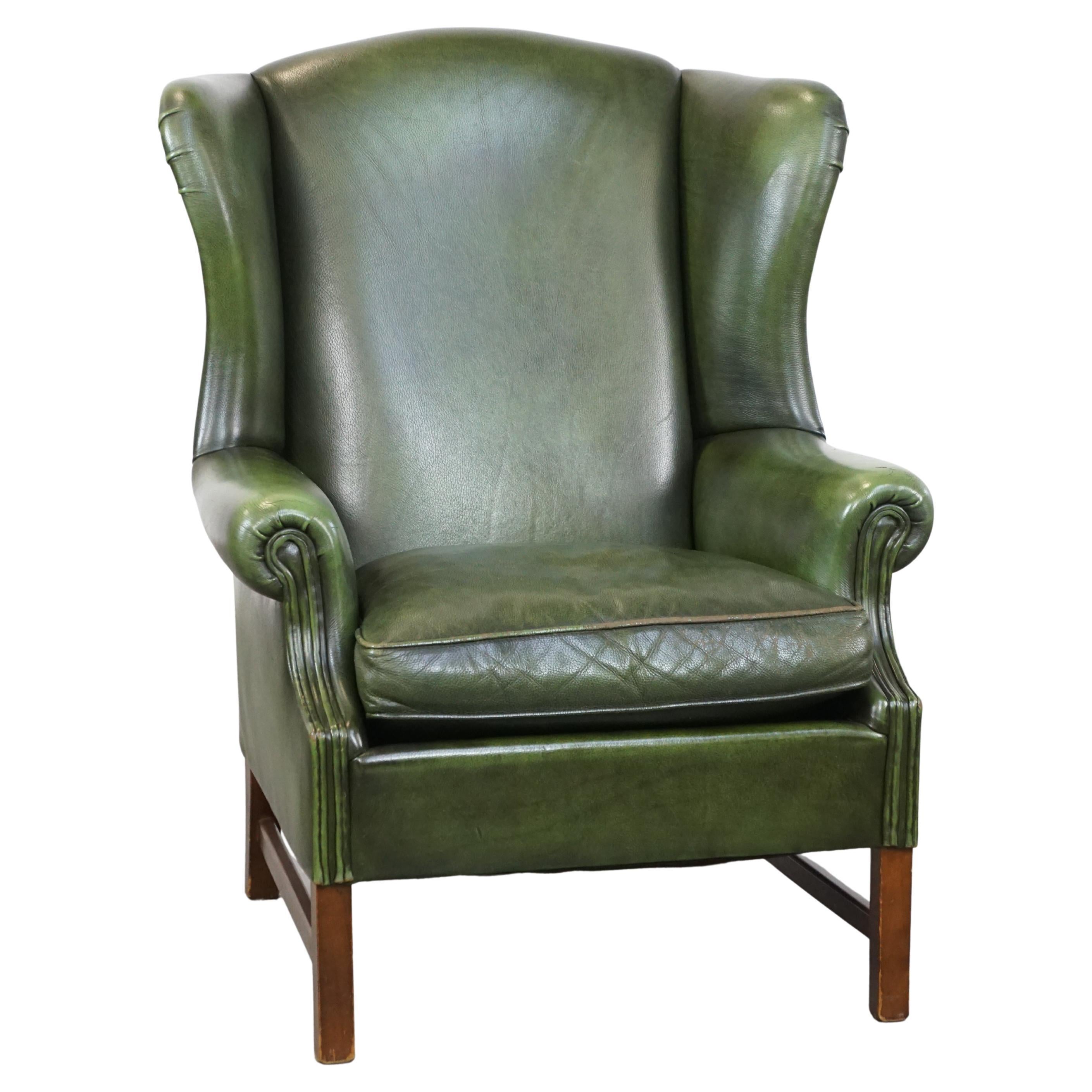 Classic green cowhide English Chesterfield wing chair with a comfortable seat For Sale