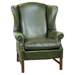 Classic green cowhide English Chesterfield wing chair with a comfortable seat