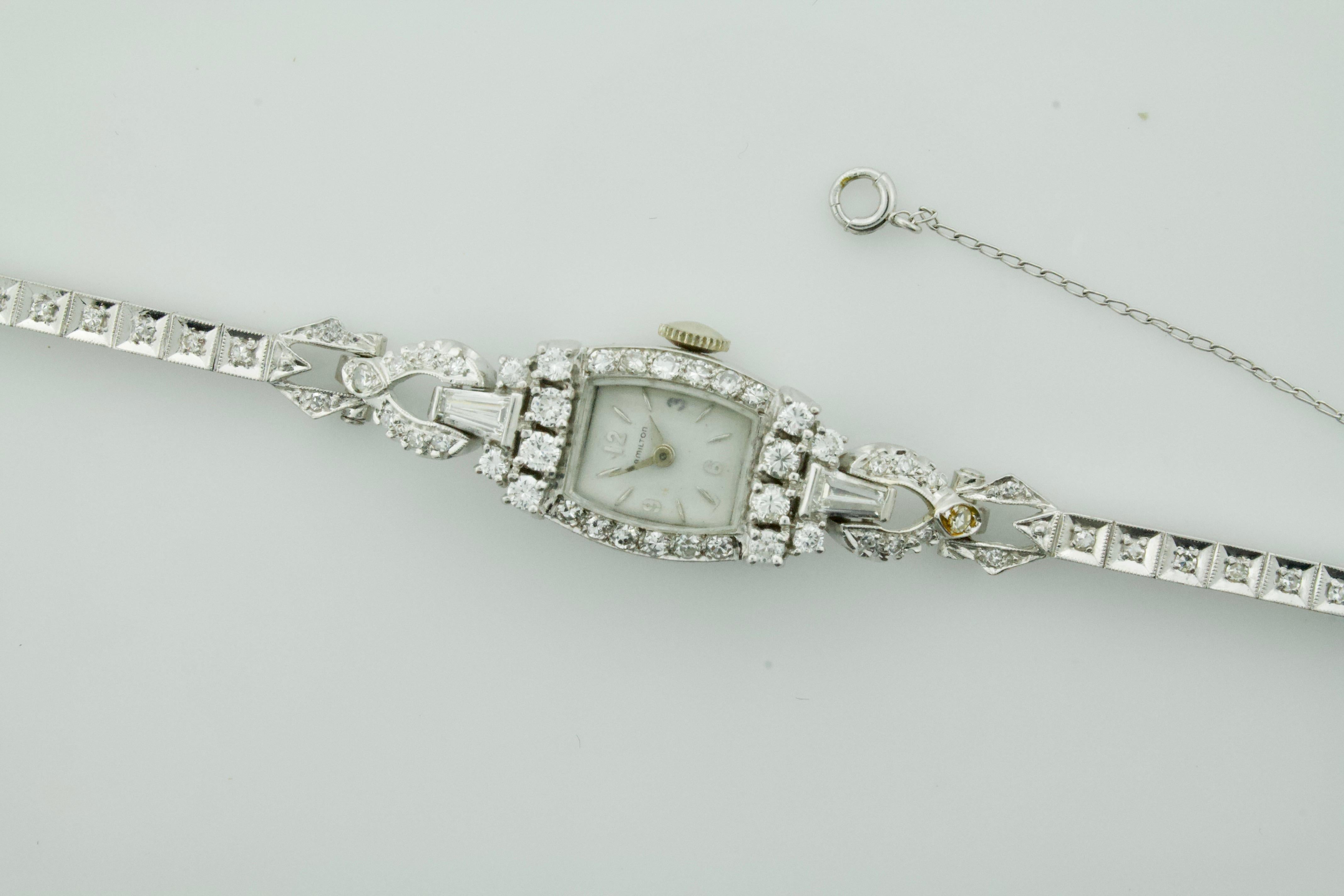 Hamilton Platinum Diamond Watch circa 1930's 1.55 carats
Two Tapered Baguette Cut Diamonds weighing .50 carats approximately
Twelve Round Brilliant Cut Diamonds weighing .55 carats approximately
Fifty Nine Round Cut Diamonds weighing .50 carats