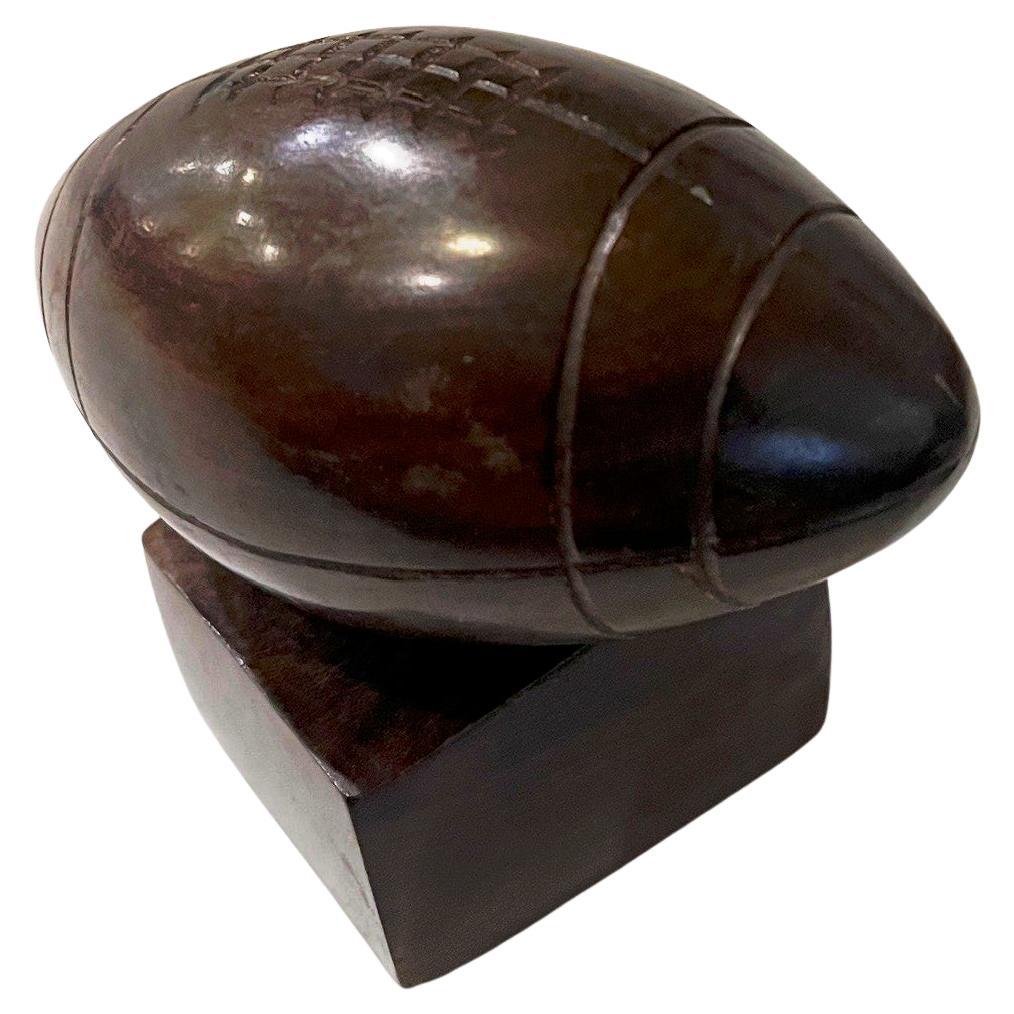 Beautiful hand-carved solid ironwood football circa 1970's great detail and condition, polished ball sitting on a pedestal , a classic of American memorabilia. perfect for a Game lover Desk top bookcase piece.