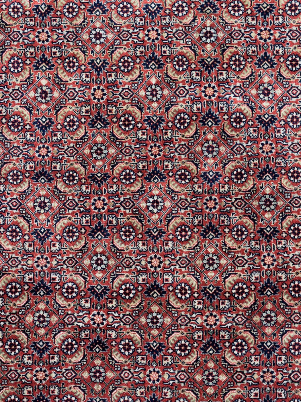 Featuring a class Persian Bidjar design, this hand-knotted carpet measures 4'6