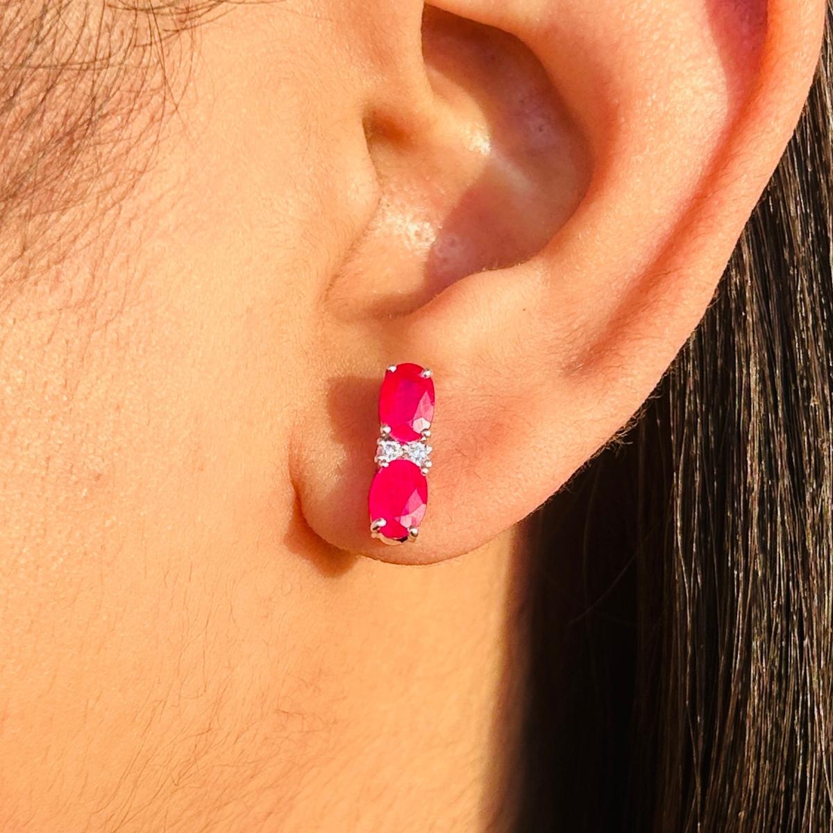 Classic Handcrafted Ruby and Zircon Stud Earrings in sterling silver to make a statement with your look. You shall need stud earrings to make a statement with your look. These earrings create a sparkling, luxurious look featuring oval cut natural