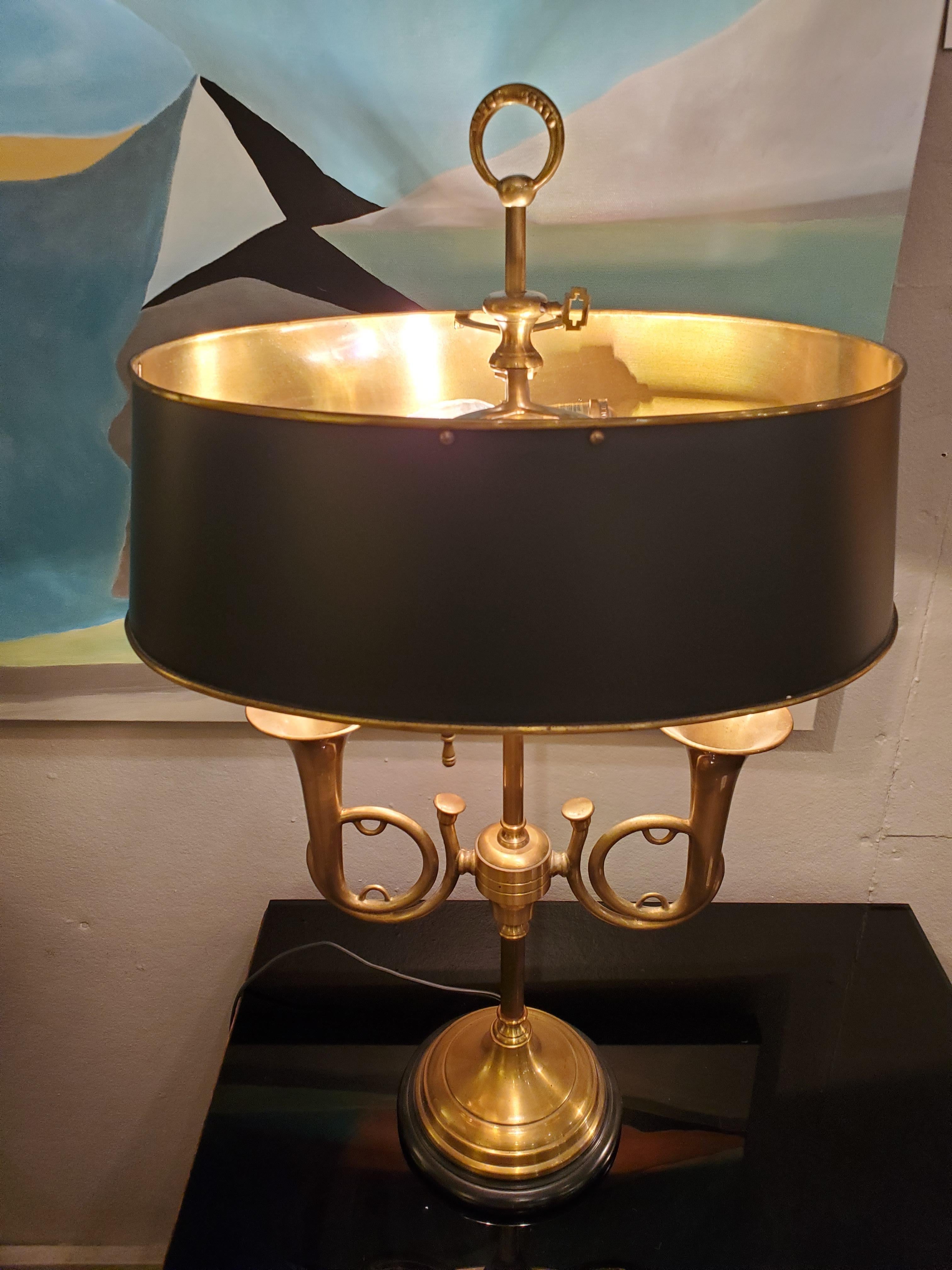 Handsome brass horn motife table lamp having black metal shade and base. A classic.
