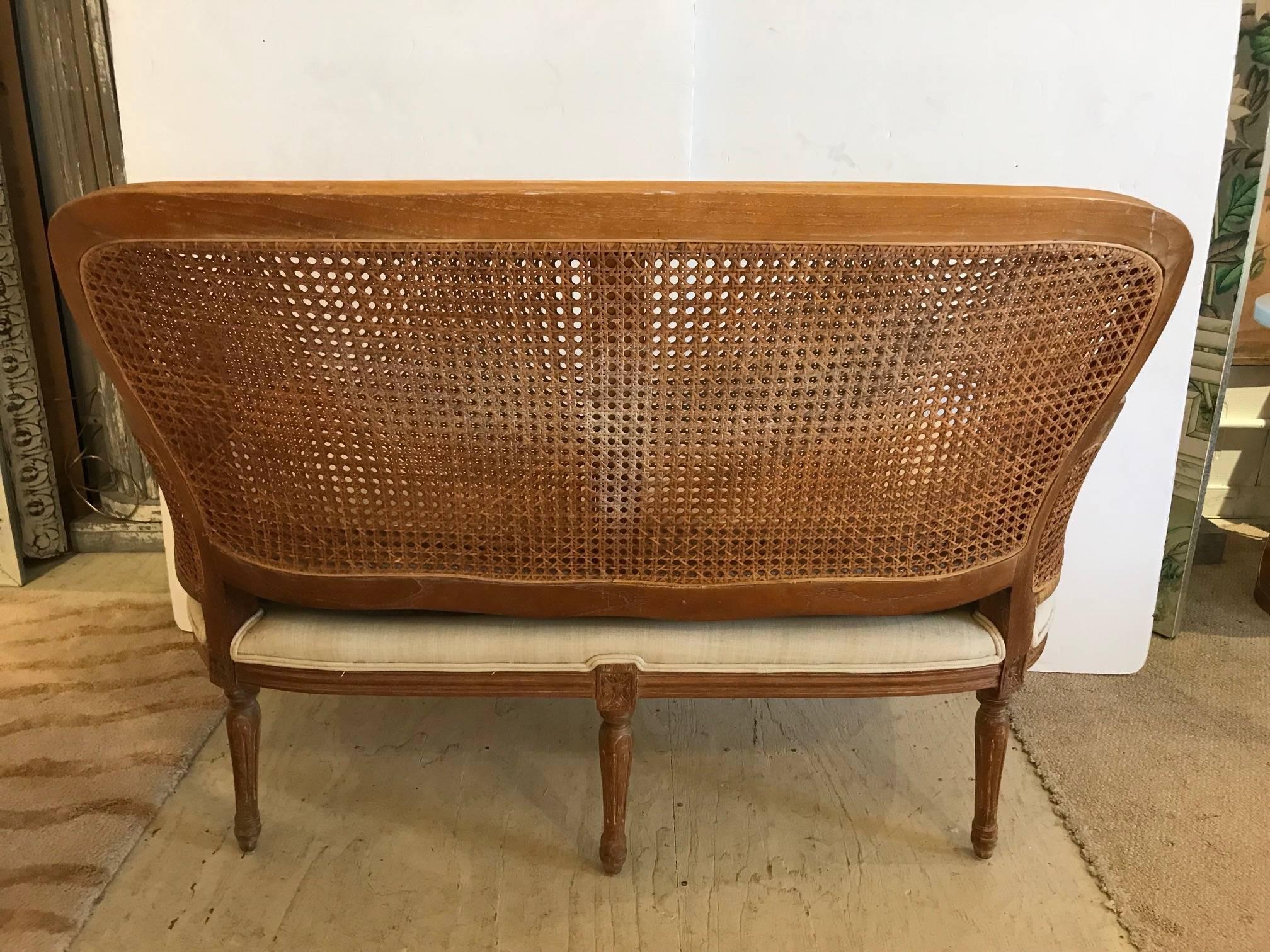 Classically elegant curved double caned loveseat having pretty carved wood arms and legs and an upholstered seat with removable seat cushion.
Measures: Seat: 22 D x 18 H.
    