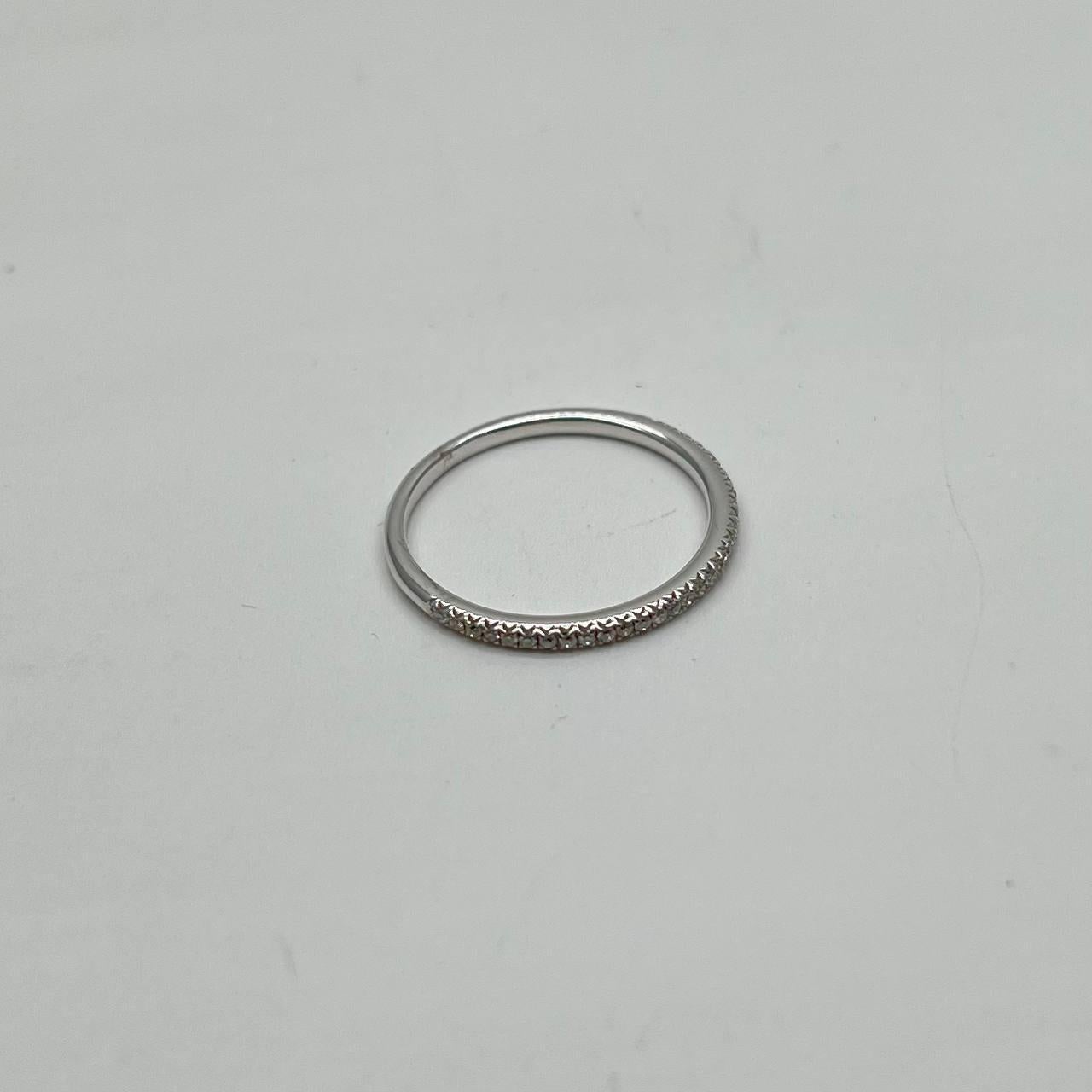 This exquisite ring is crafted in 14k white gold. It features a brilliant cut white diamond, adding a touch of sparkle to its sleek design. The band is simple yet refined, allowing the diamond to be the focal point. 
Primary Stone: Diamond
Carat