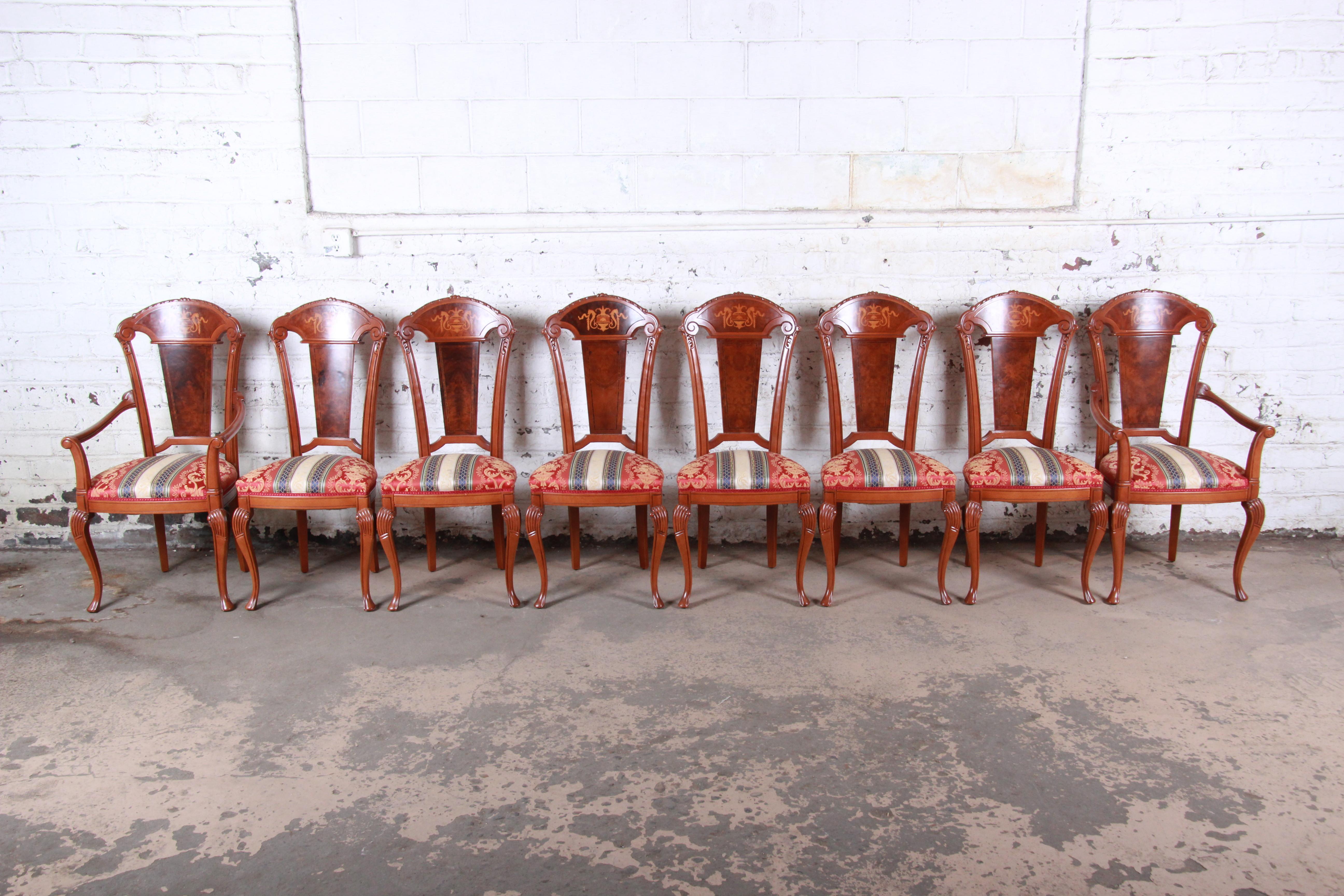 A gorgeous set of eight traditional Italian carved and inlaid dining chairs

Italy, mid-20th century

Solid maple, with burl wood backs with decorative inlay and upholstered seats.

Measures:
Side chairs 19.25