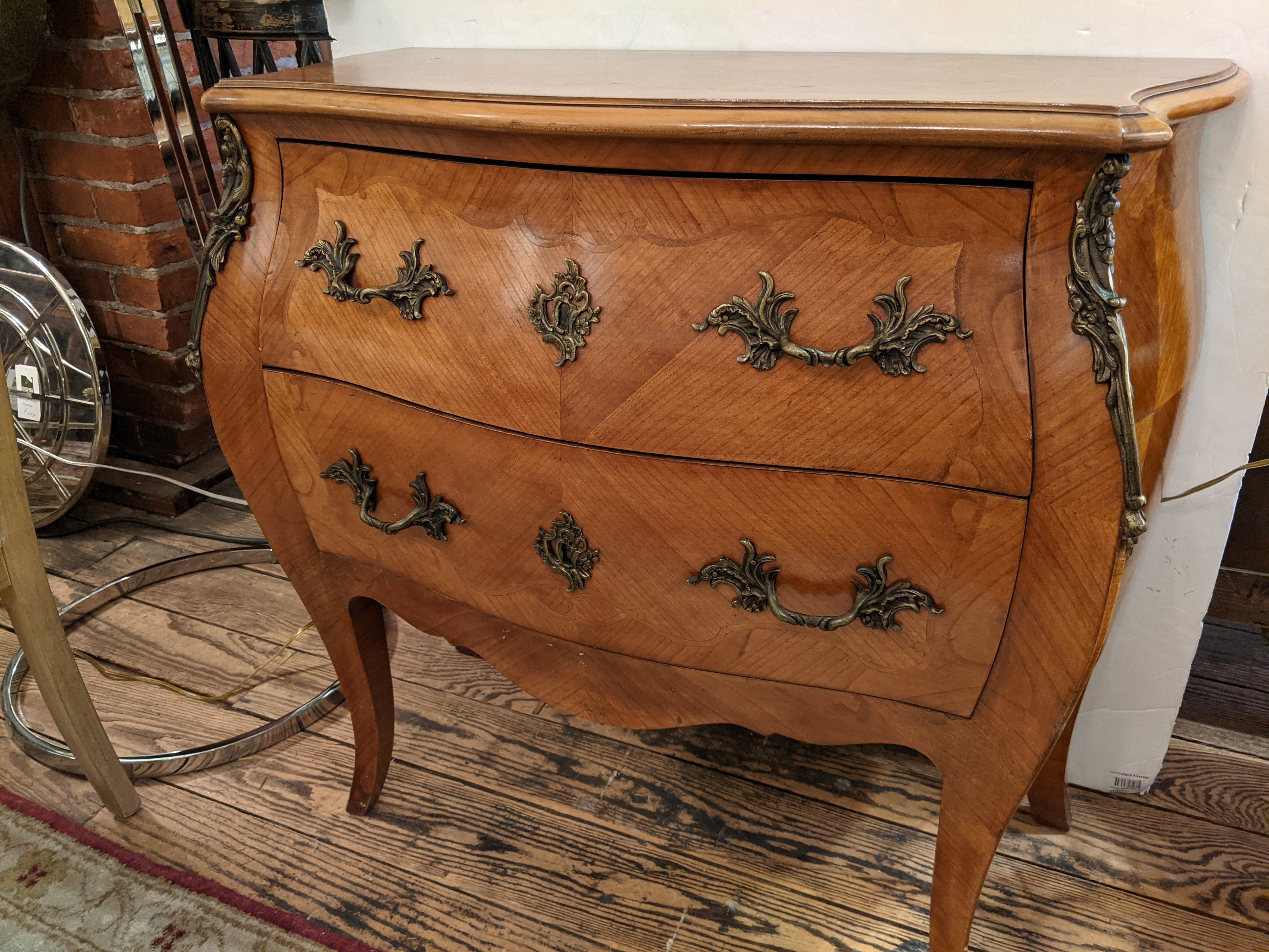 Lovely two drawer medium sized Italian commode in the classic bombe style. Ormulu decoration in all the right places and original pretty aged brass hardware.