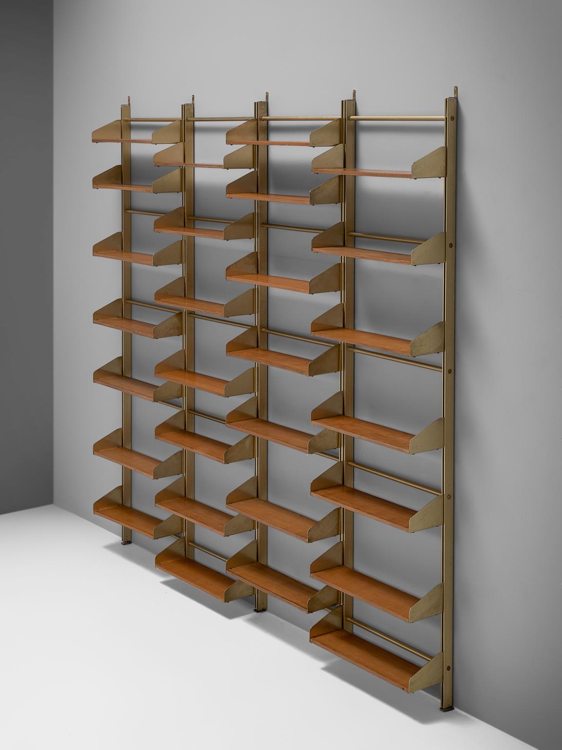 FEAL, Wall unit, teak brass and brassed aluminum, Italy, 1950s. 

This eloquent wall unit from Italy is made with a brassed aluminum frame and connective joints and plenty of teak shelves. The combination of the brass and teak is both modest and