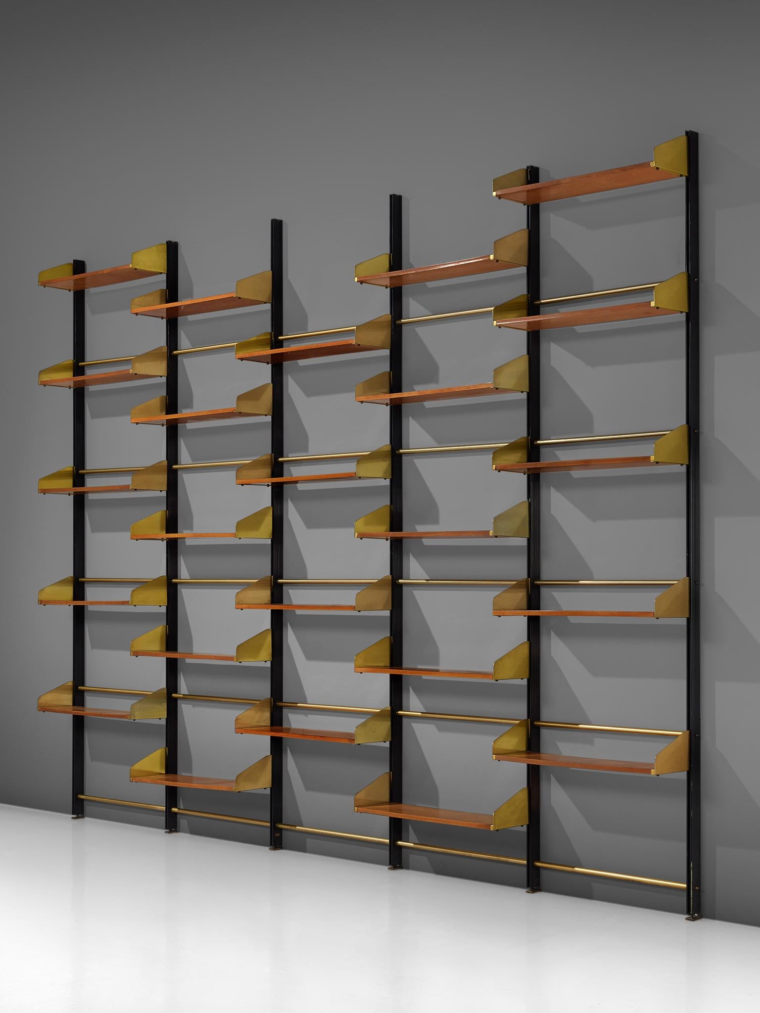 Feal, wall unit, teak brass and brassed aluminum, Italy, 1950s. 

This eloquent wall unit from Italy is made with a brassed aluminum frame and connective joints and plenty of teak shelves. The combination of the brass and teak is both modest and