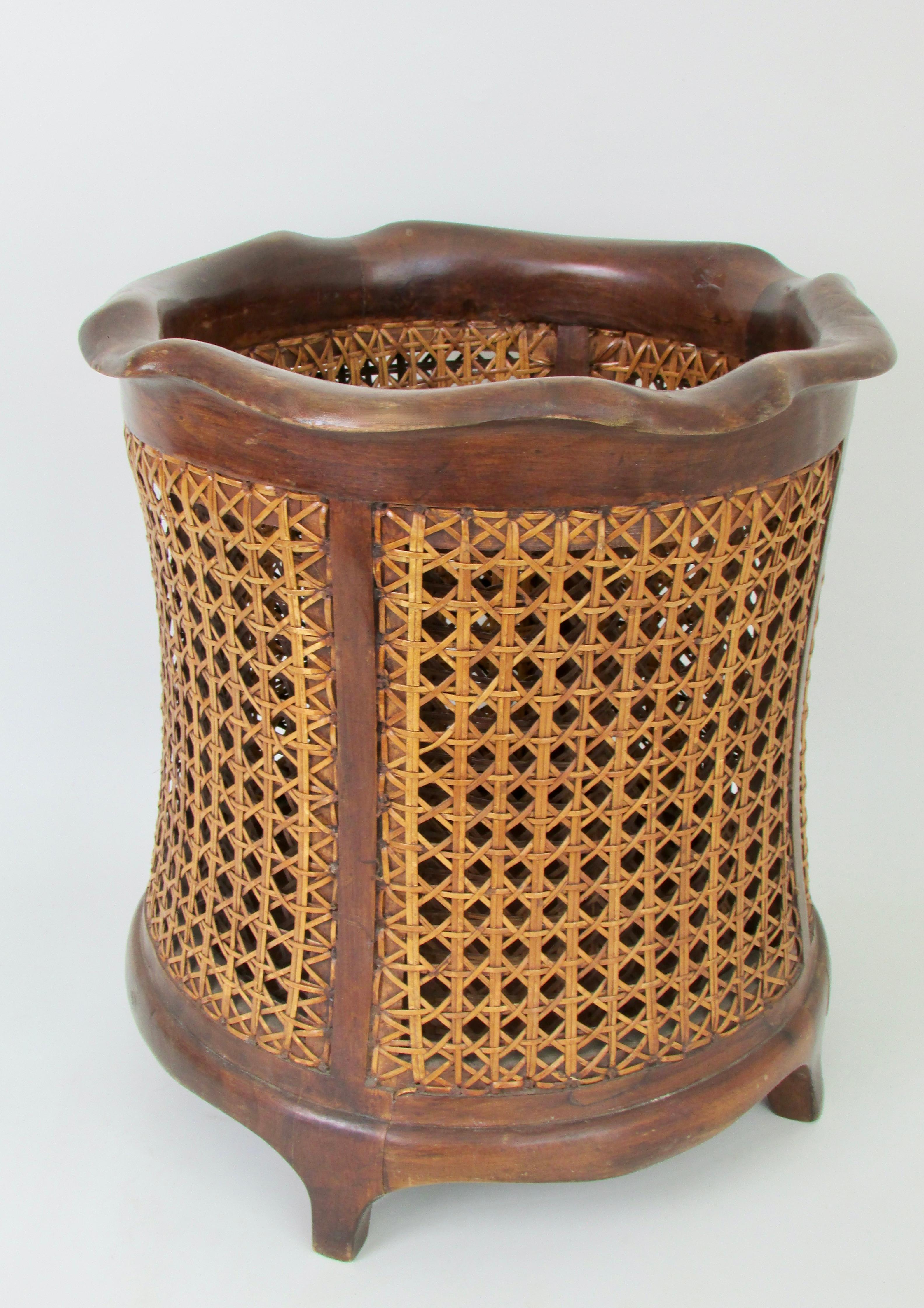 Elegant solid walnut frame waste basket with hand caned panels on the interior and exterior . Trash can stands on four feet stamped Made in Italy with VI stamped on the underside . Fine condition in original finish .