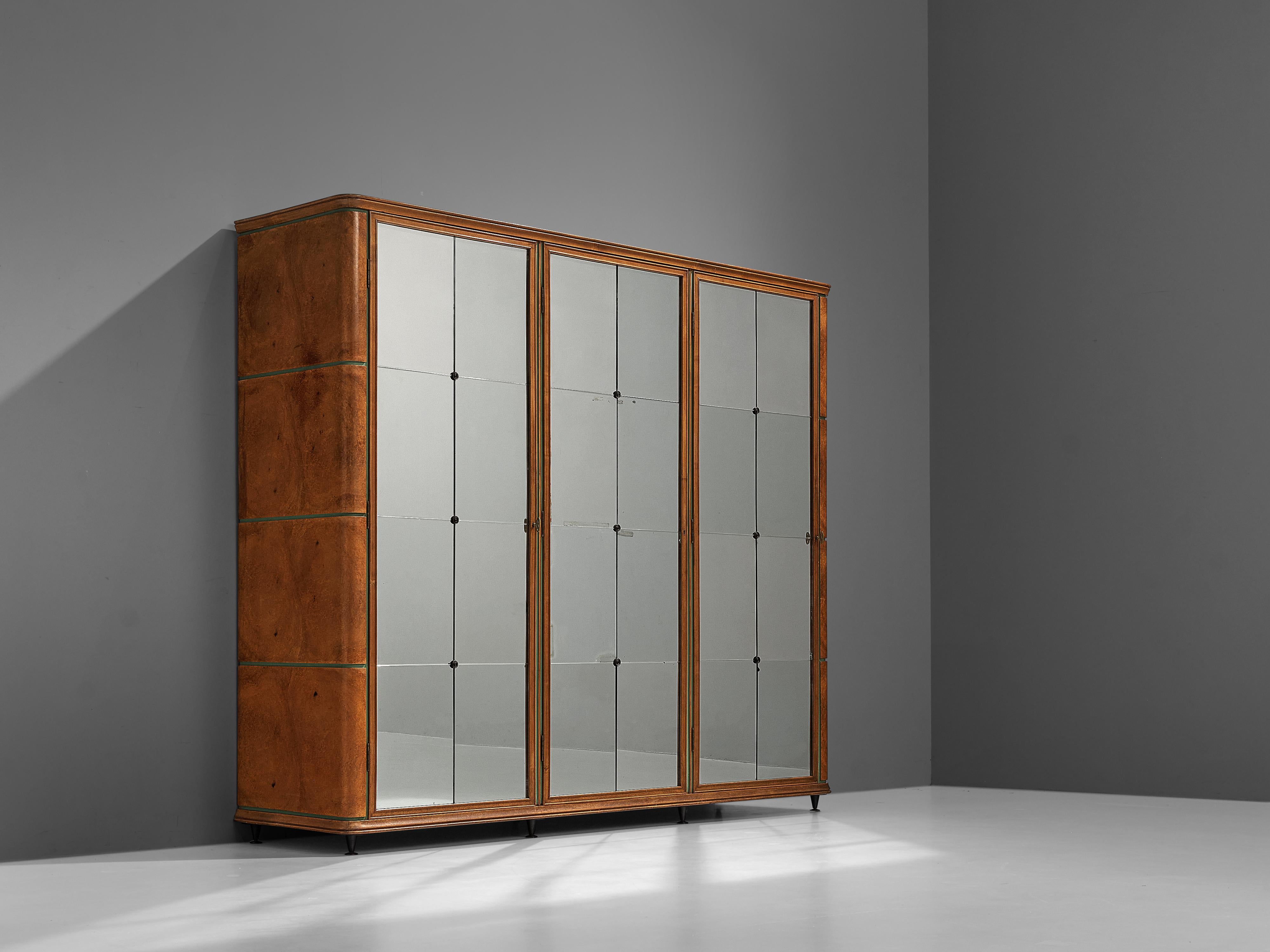Italian wardrobe, oak, brass, mirrors, 1950s

Luxurious wardrobe in oak with a classic and sophisticated look. The three doors are designed with elegant mirrored doors that have detailed brass elements. These patinated mirrors have a lined surface