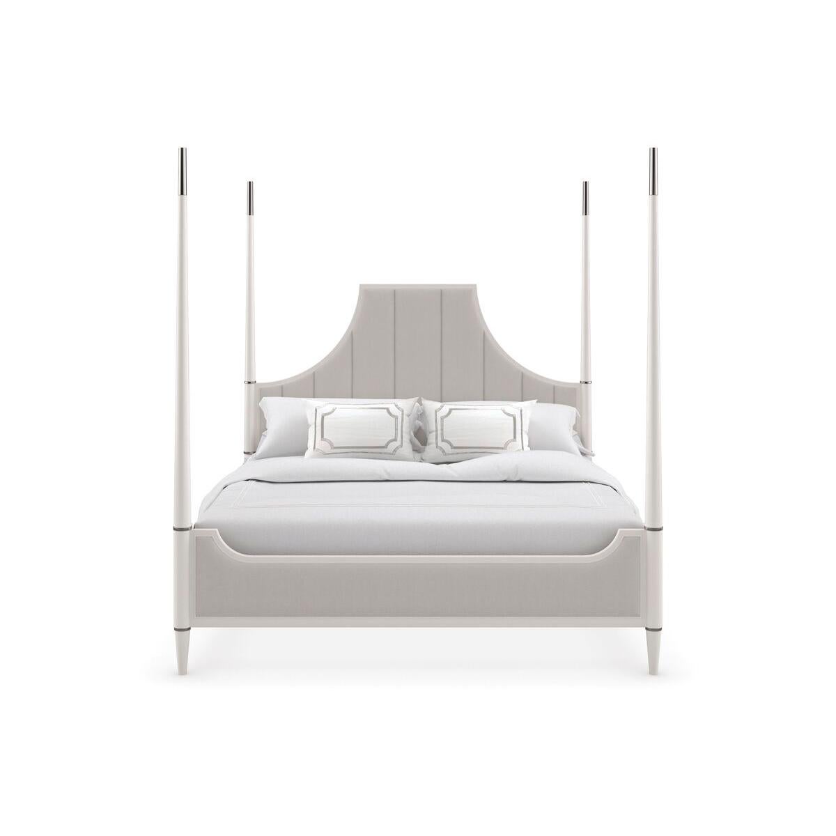 With a traditional overtone, this classic bed offers an elegant and stately design that showcases a sophisticated blend of modern and classic elements. The bed features a unique, high-backed canopy-style headboard, which curves inward, creating an