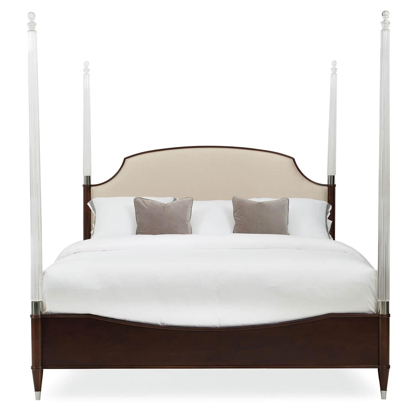 A Classic king size lucite four-post with an upholstered headboard. This beautiful bed has a Classic design with elegant modern details including clear acrylic posts and stainless steel ferrules. It has a wood footboard and side rails finished in