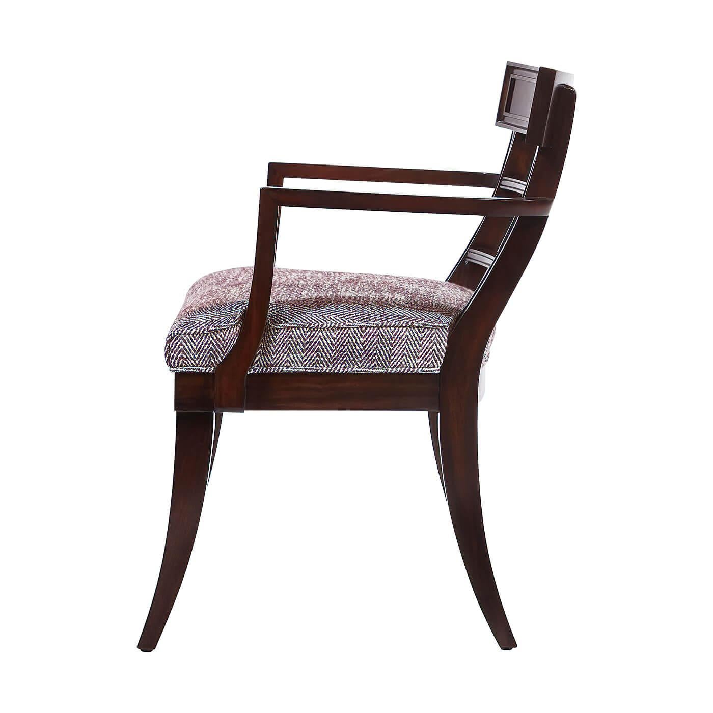 The typical lead time is 12- 16 weeks.
A Regency style classic klismos form armchair with a channel reeded frame on the upper back, recessed back rails with channel detail, and recessed rosettes above slim slightly curved legs. An upholstered seat