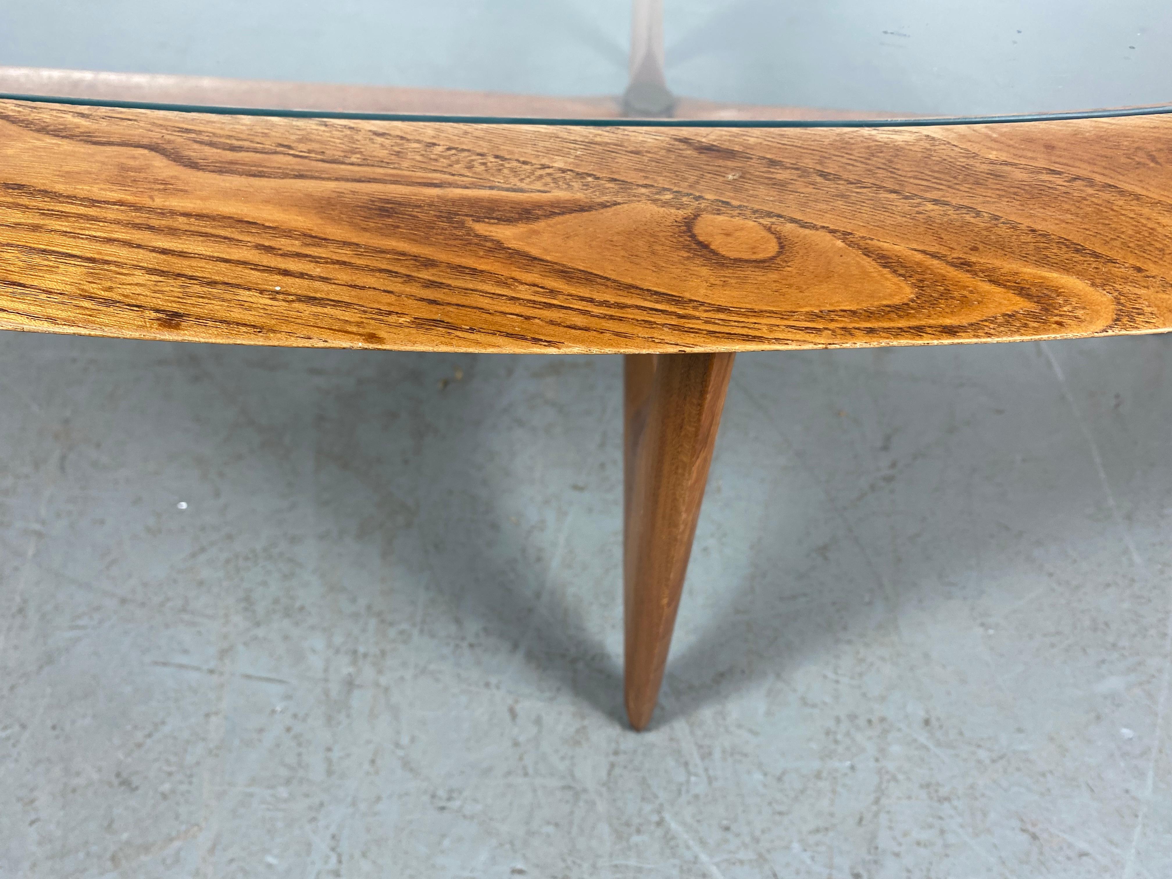 This mid-century coffee table by Lane features a unique kidney shape in the style of Adrian Pearsall. Its solid walnut construction and sculpted base offer a modern flare to any home or office.Hand delivery avail to New York City or anywhere en