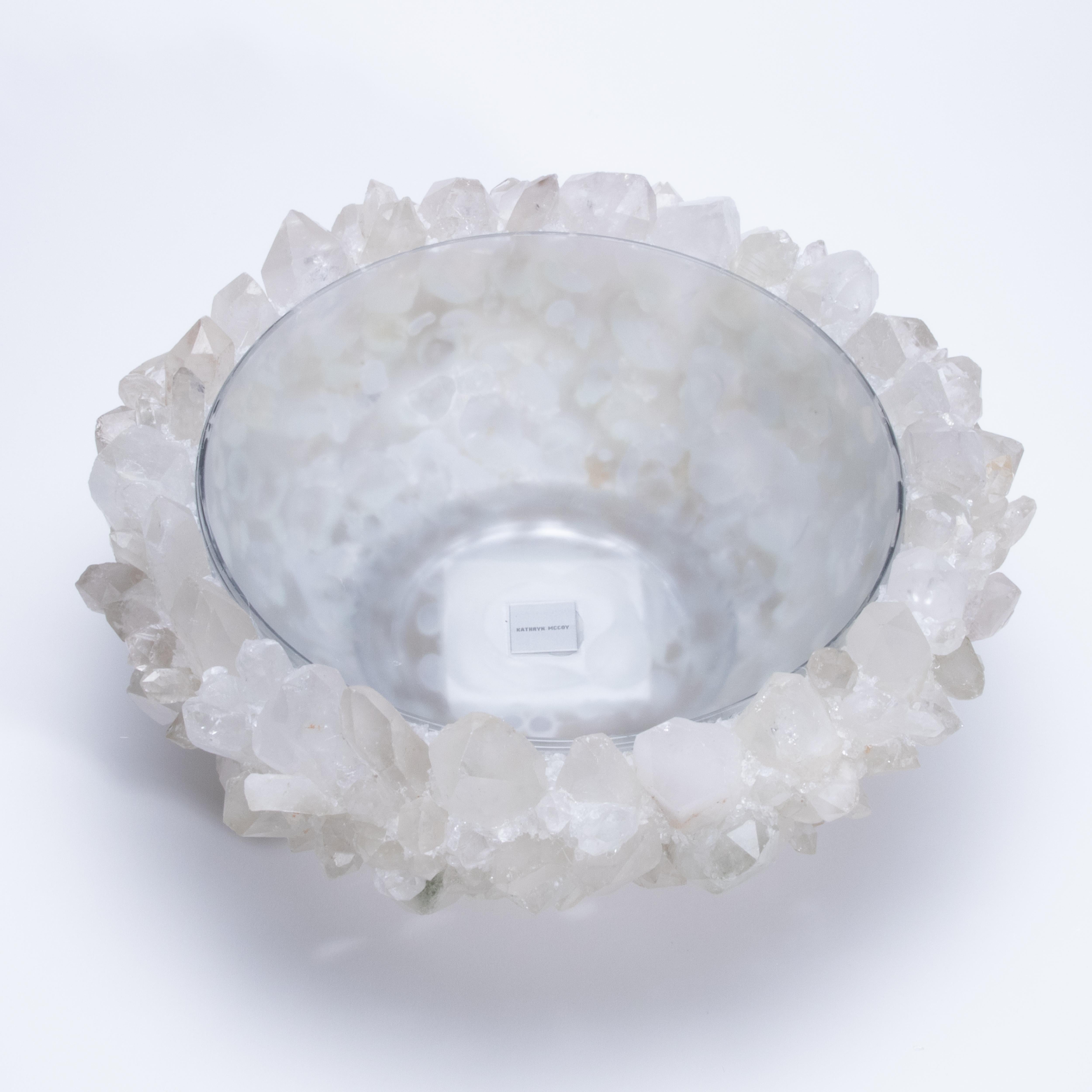 Glowing with quiet brilliance, the Classic Large Bowl in Clear Quartz by Kathryn McCoy exudes an elemental elegance that feels both grounded and celestial. Handcrafted from clusters of luminous clear quartz and finished with a smooth, glass-lined