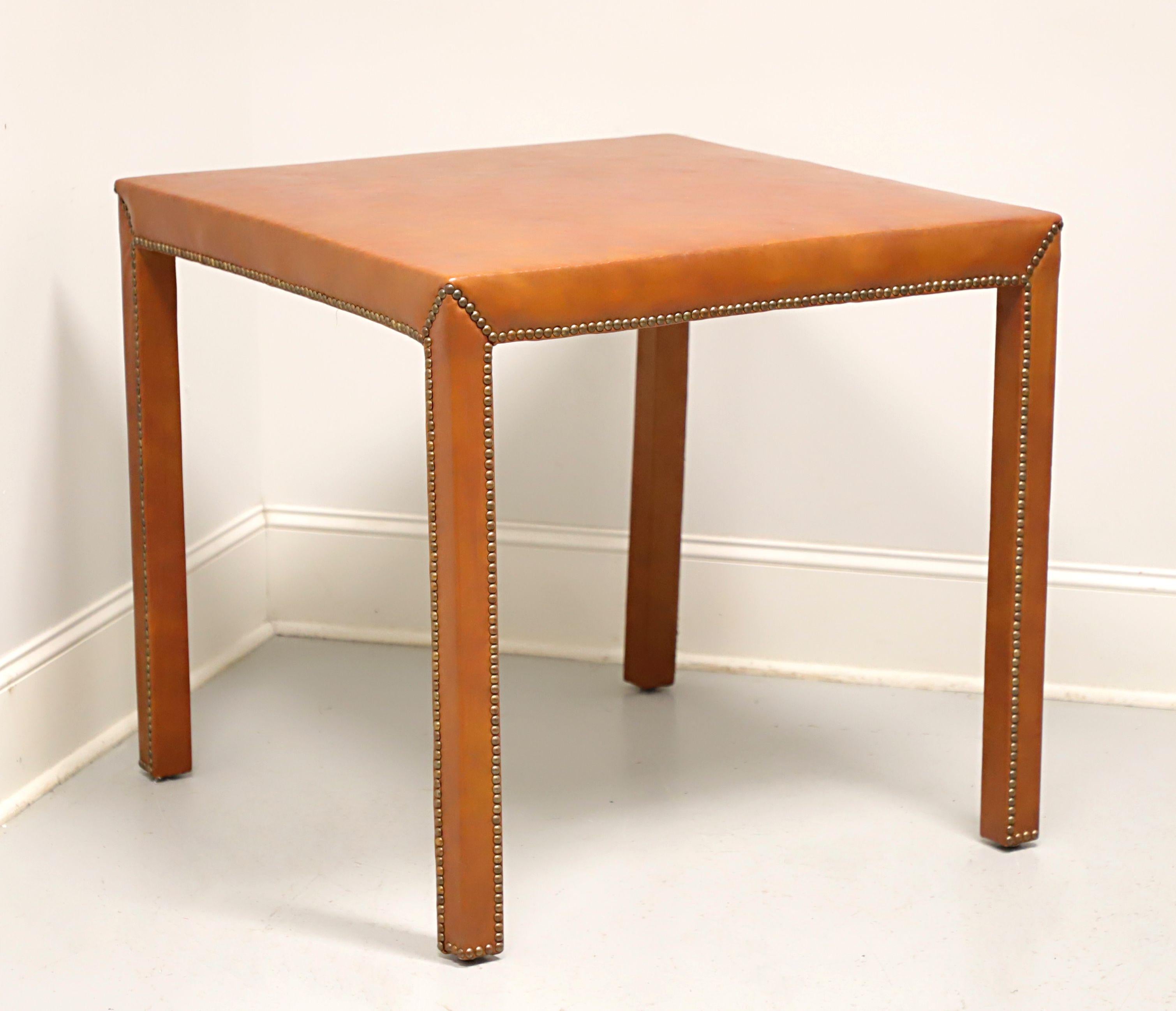 A Traditional style game table by Classic Leather. Solid wood frame covered in a light brown color leather, brass nailhead trim, and straight front legs. Made in Conover, North Carolina, USA, in the mid 20th Century.

Measures: 32.5w 32.5d 30h, Knee