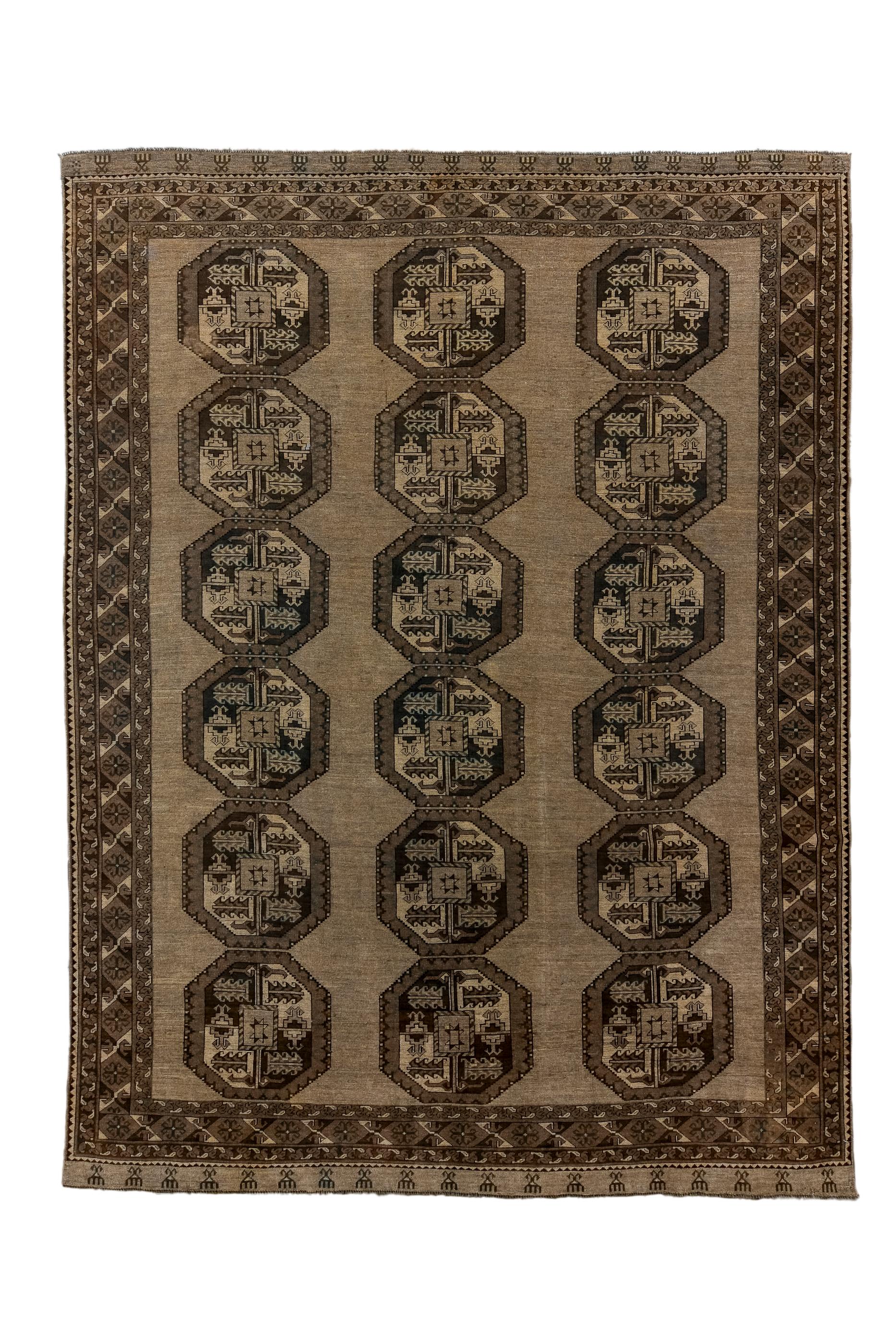 The light brown field shows three spaciously set columns of six octagonal “Ongurghe” guls without, unusually any minor guls.  This presents a particularly direct, primitive effect. Major border with X’s and hexagons. Moderate/coarse weave, all-wool