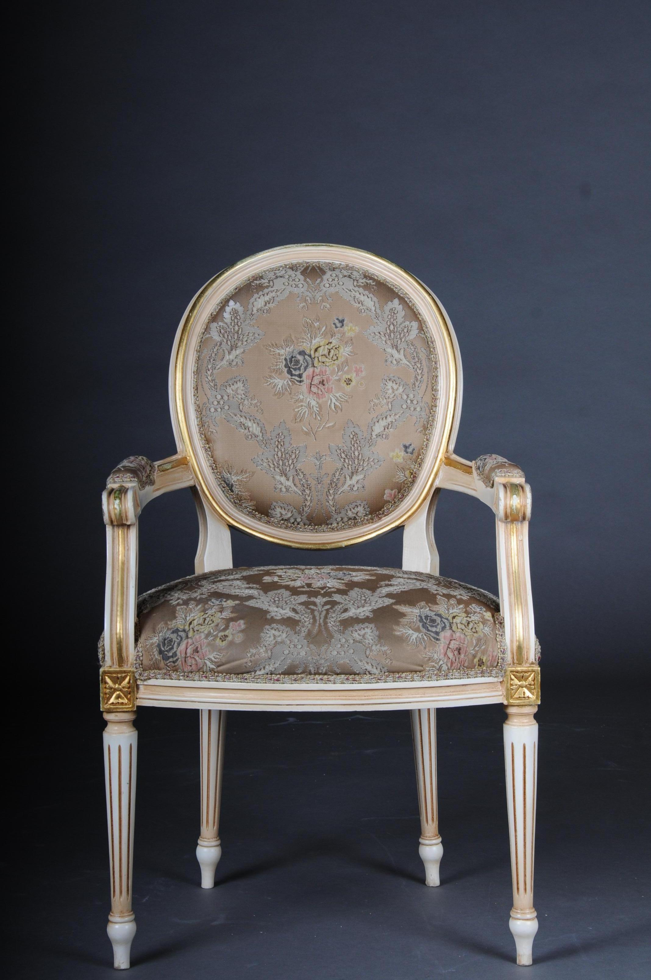 Classic Louis XVI armchair, 20th century

Solid wood, painted cream and partly gilded. Cambered and carved frame on curved feet.
The seat and backrest are finished with historical, Classic upholstery. Pointed legs. Width seat u. Upholstered