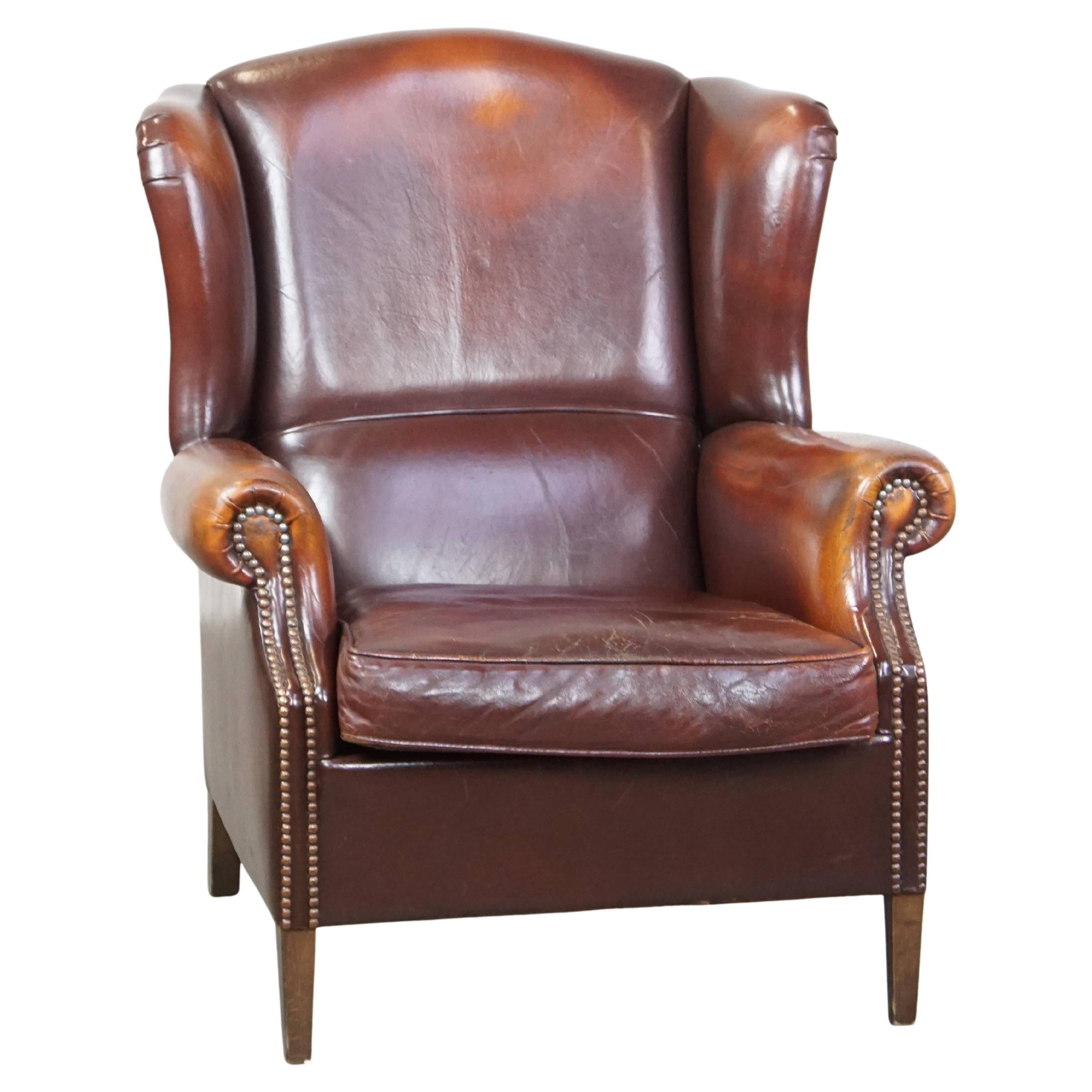 Classic, luxurious, and comfortable dark English-style sheepskin wingback chair