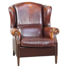 Classic, luxurious, and comfortable dark English-style sheepskin wingback chair