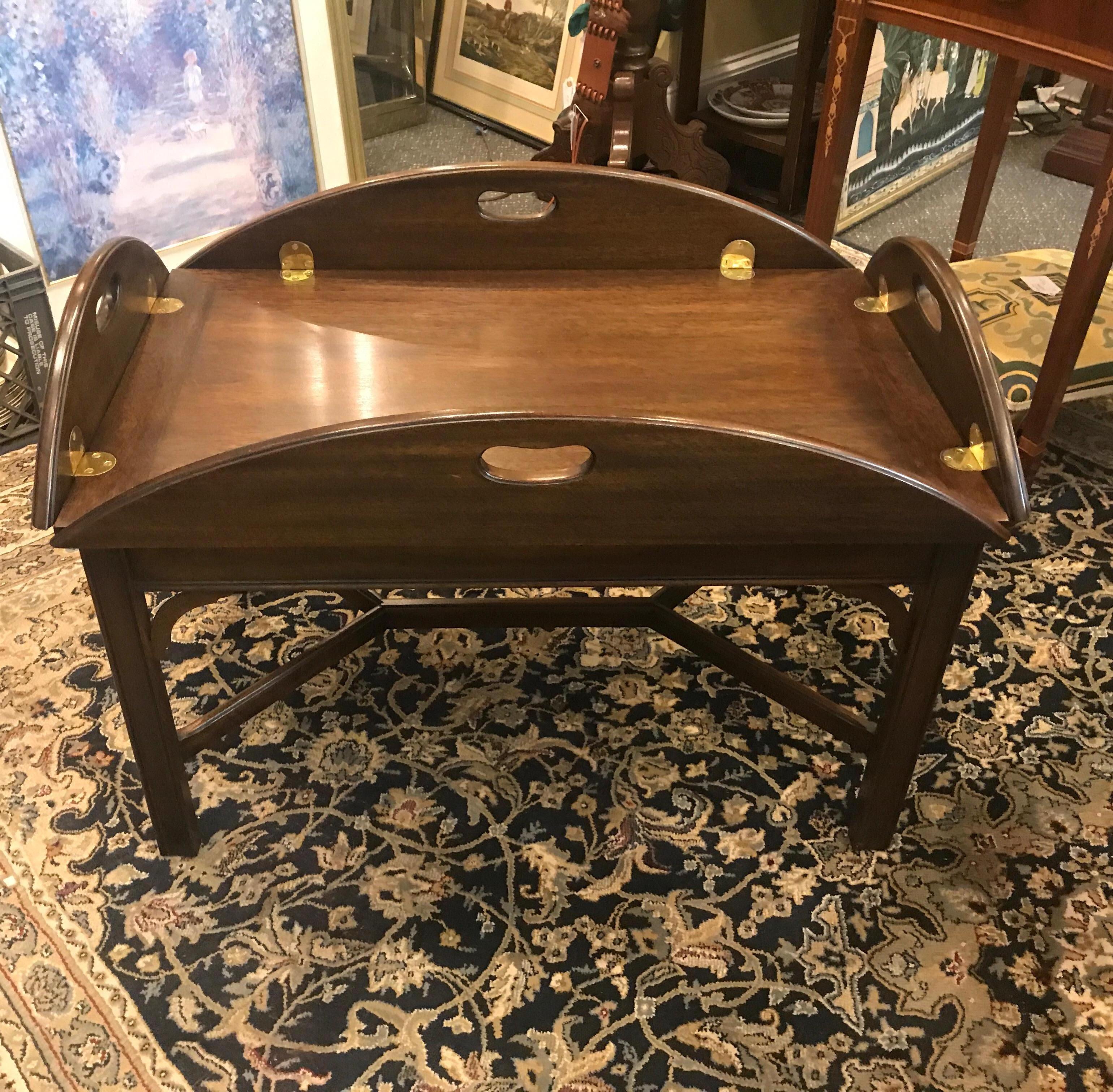 A Classic English style Butlers table. The table with small leaves on all four sides with brass hinged. Leaves up, 33 by 21, leaves down 41 by 30. Made by Virginia Galleries.