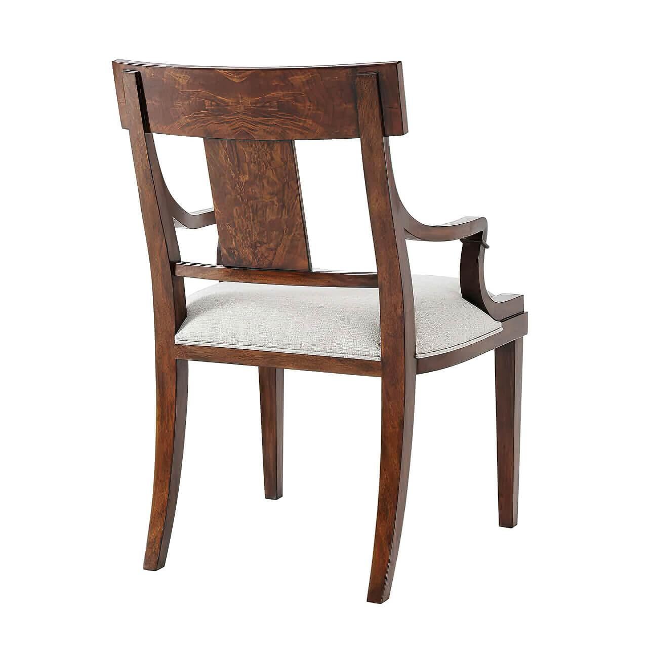 A Classic mahogany dining armchair, the flame mahogany veneered bar top rail and solid splat above an upholstered seat, on square tapering legs.

Dimensions: 23
