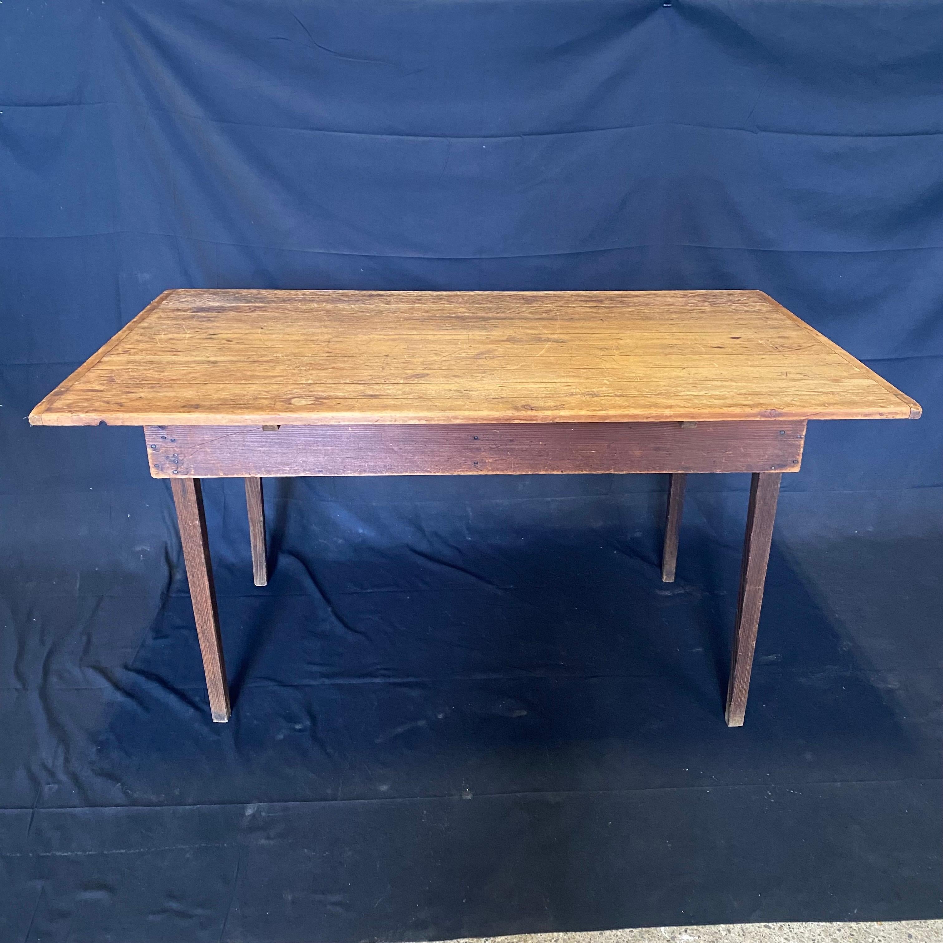 Hard to find antique American pine farm table having plant top and faded red paint on the base with a beautiful authentic patina. This versatile size could also serve as a desk. Found in Maine. #5638.