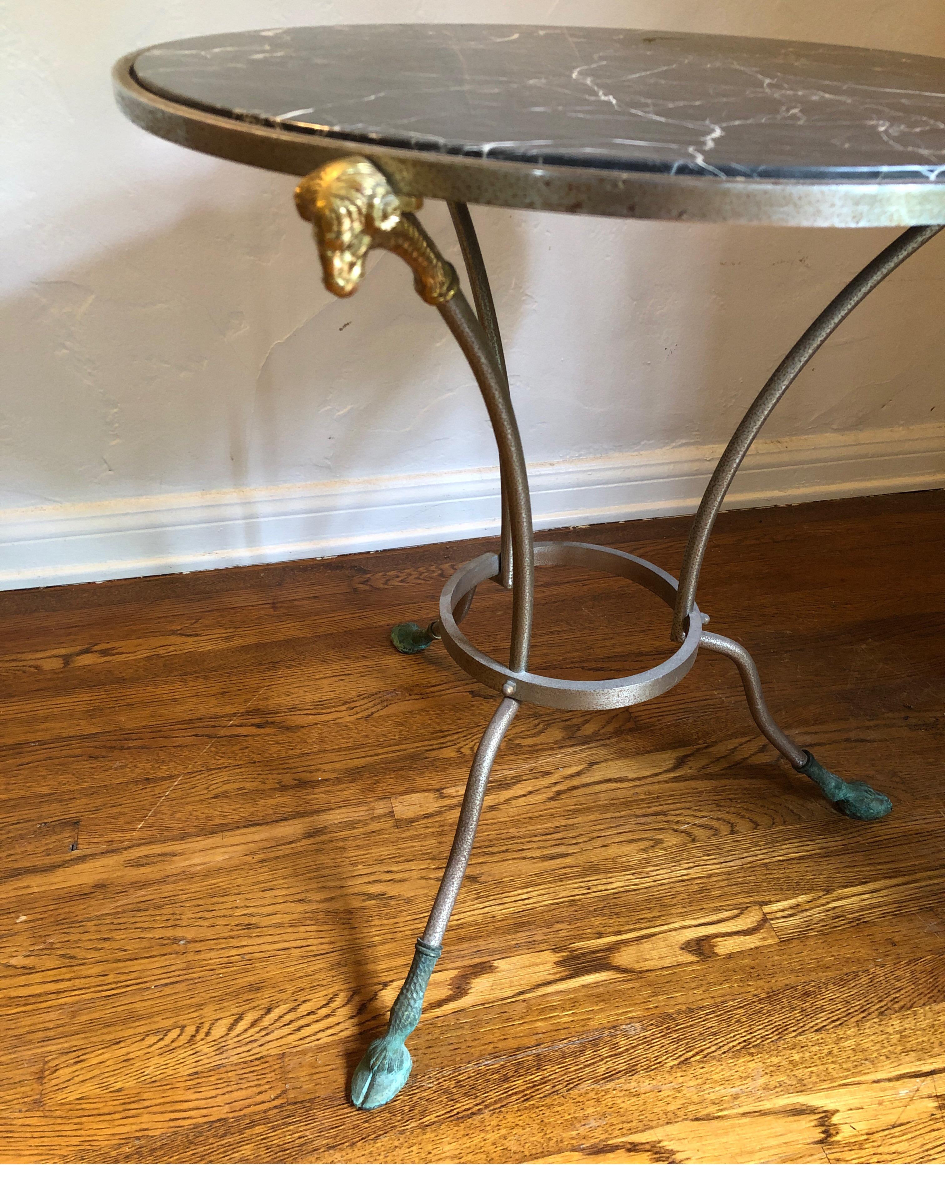 French marble-top occasional table with brass ram heads in the Regency Maison Jansen style.
Some pitting to the steel/metal and patina on the brass feet and ram heads., etc. See pics for details.